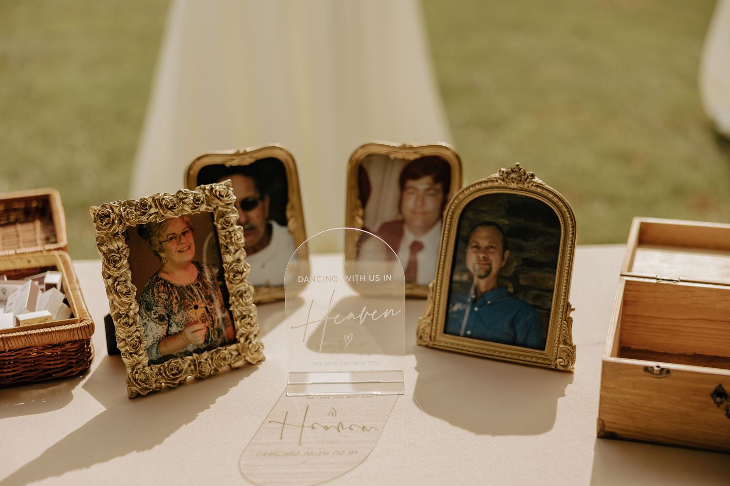 Vintage gold ornate photo frames displayed on wooden shelf with soft natural lighting in background.
