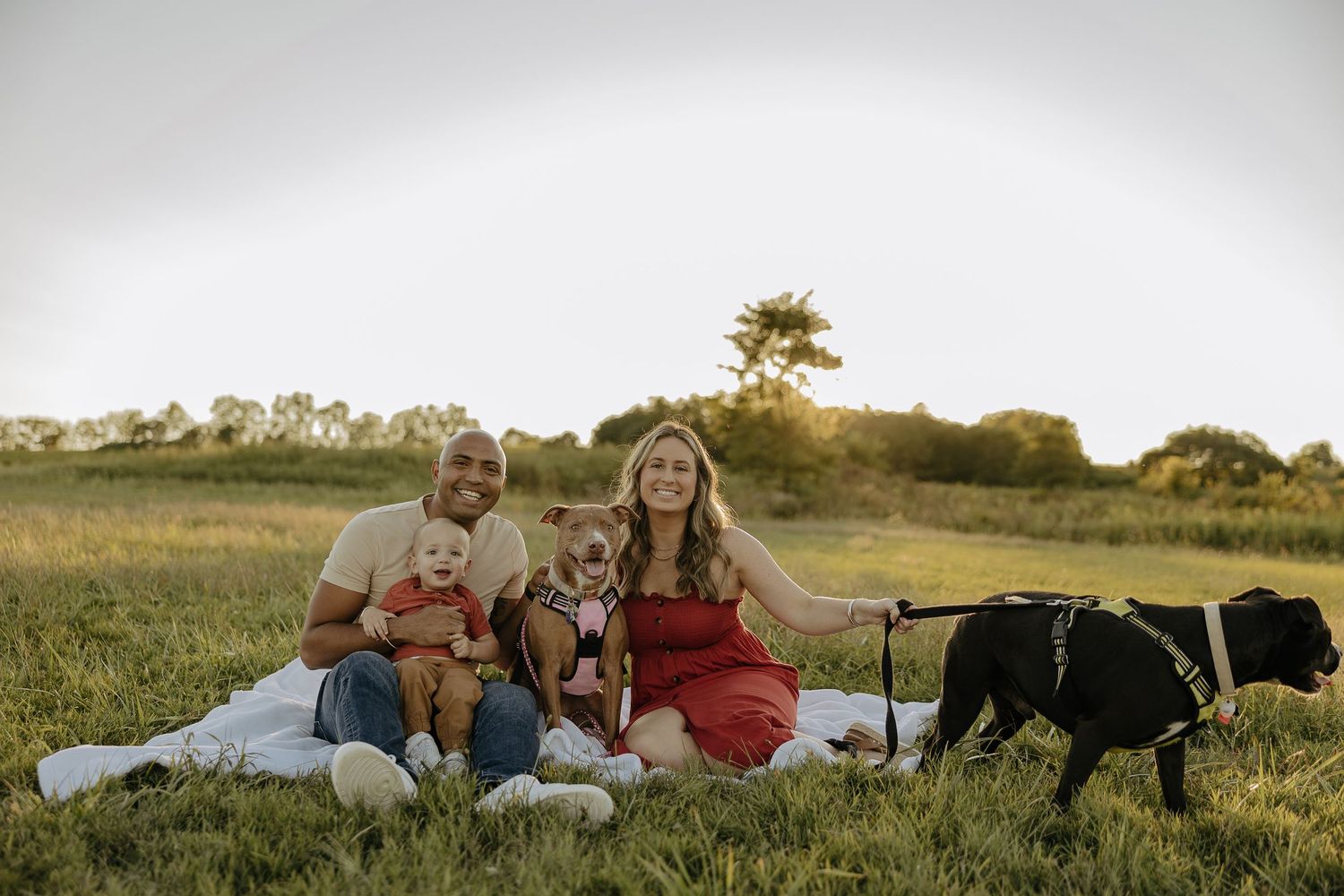 Family spending time together outdoors in a natural setting at sunset.