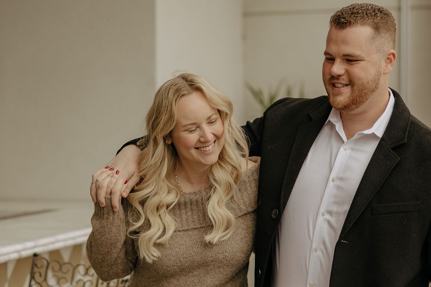 A couple shares a tender moment in a warmly lit indoor setting.