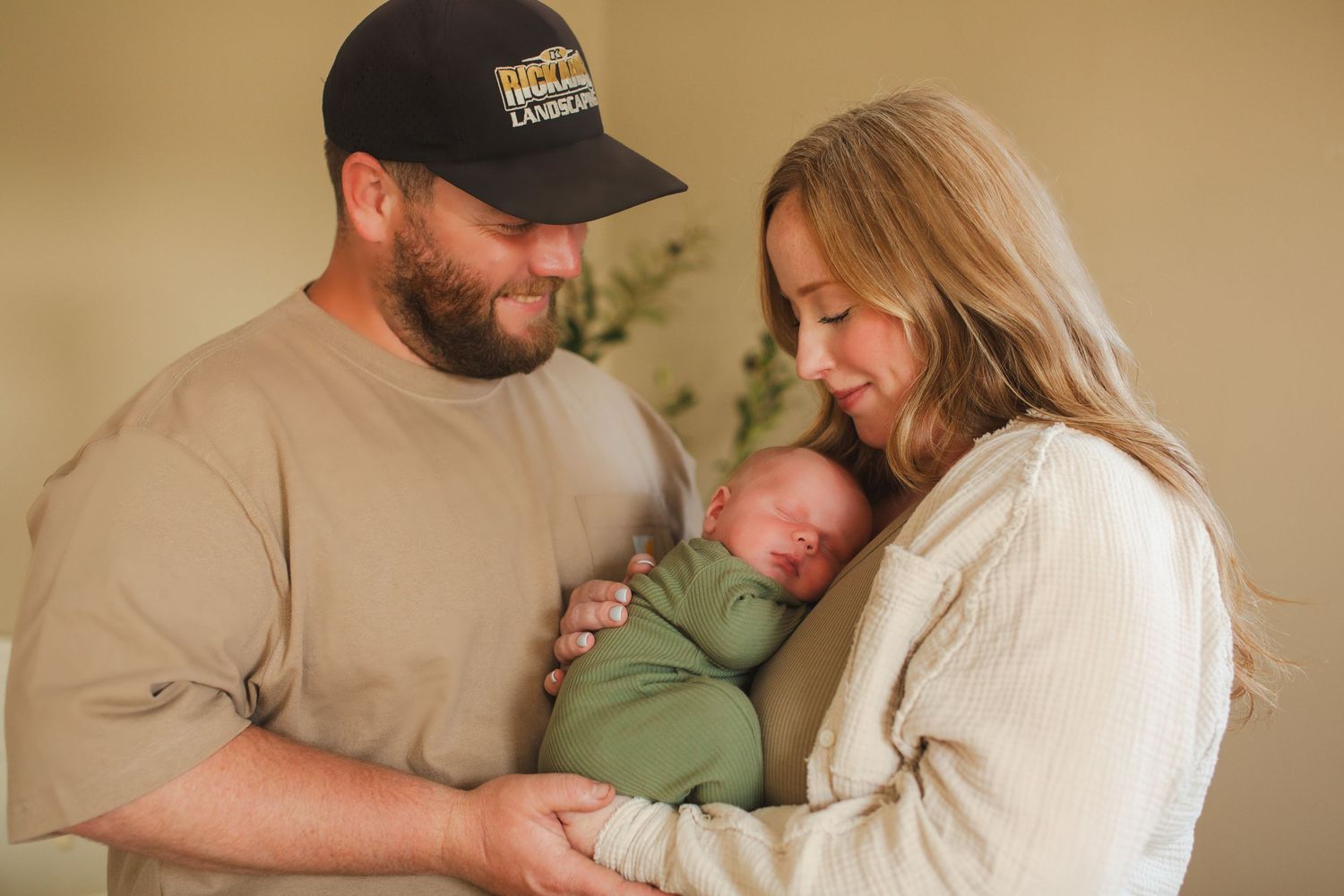 Family portrait in neutral colors with olive green and beige tones.