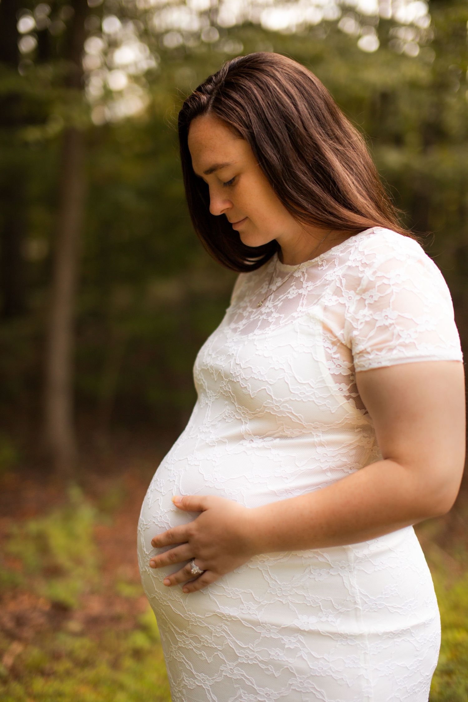 A series of maternity photos showing a woman in a white lace dress cradling her baby bump in an outdoor setting.