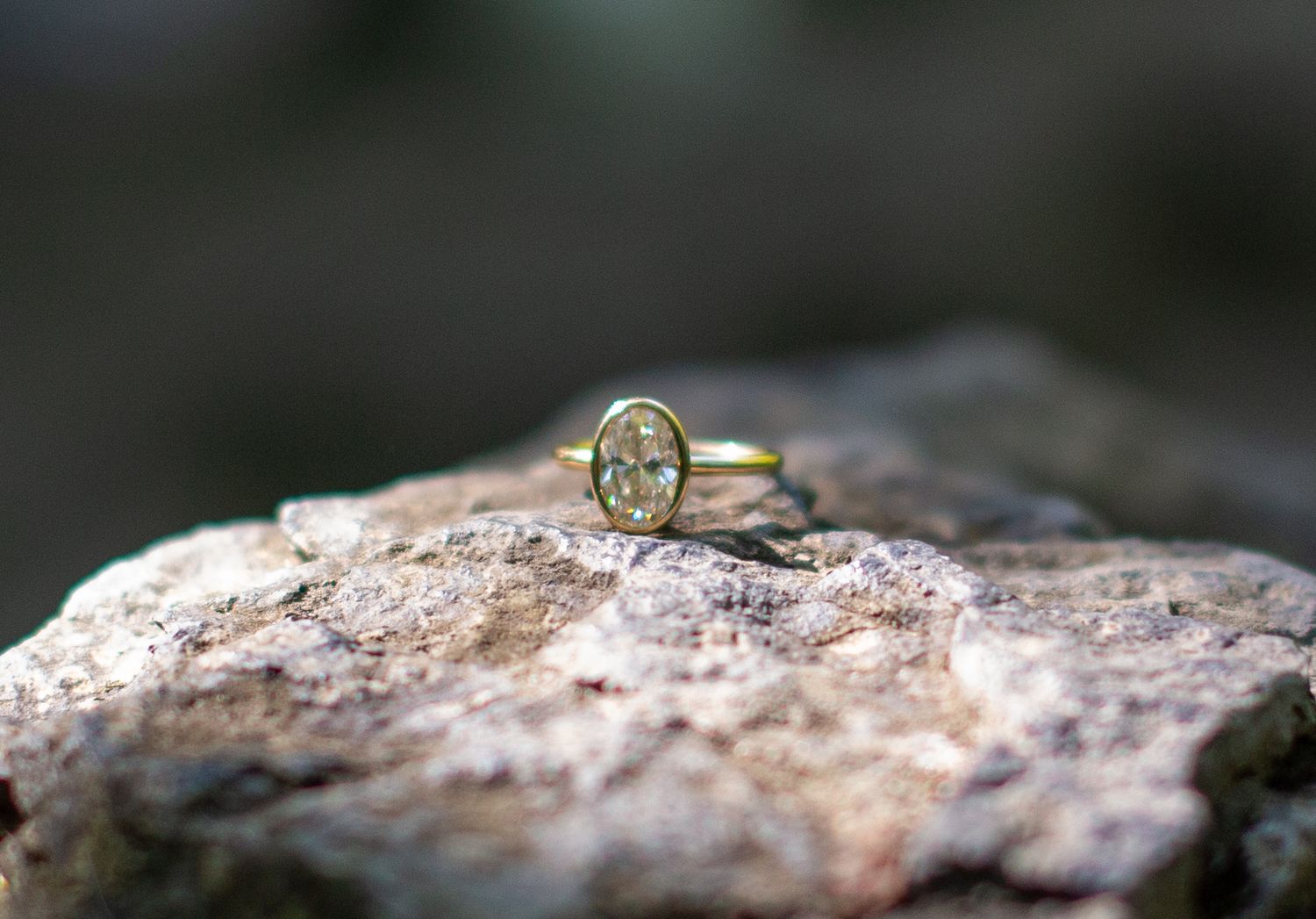 Detailed macro photography sequence of a diamond engagement ring on textured stone.