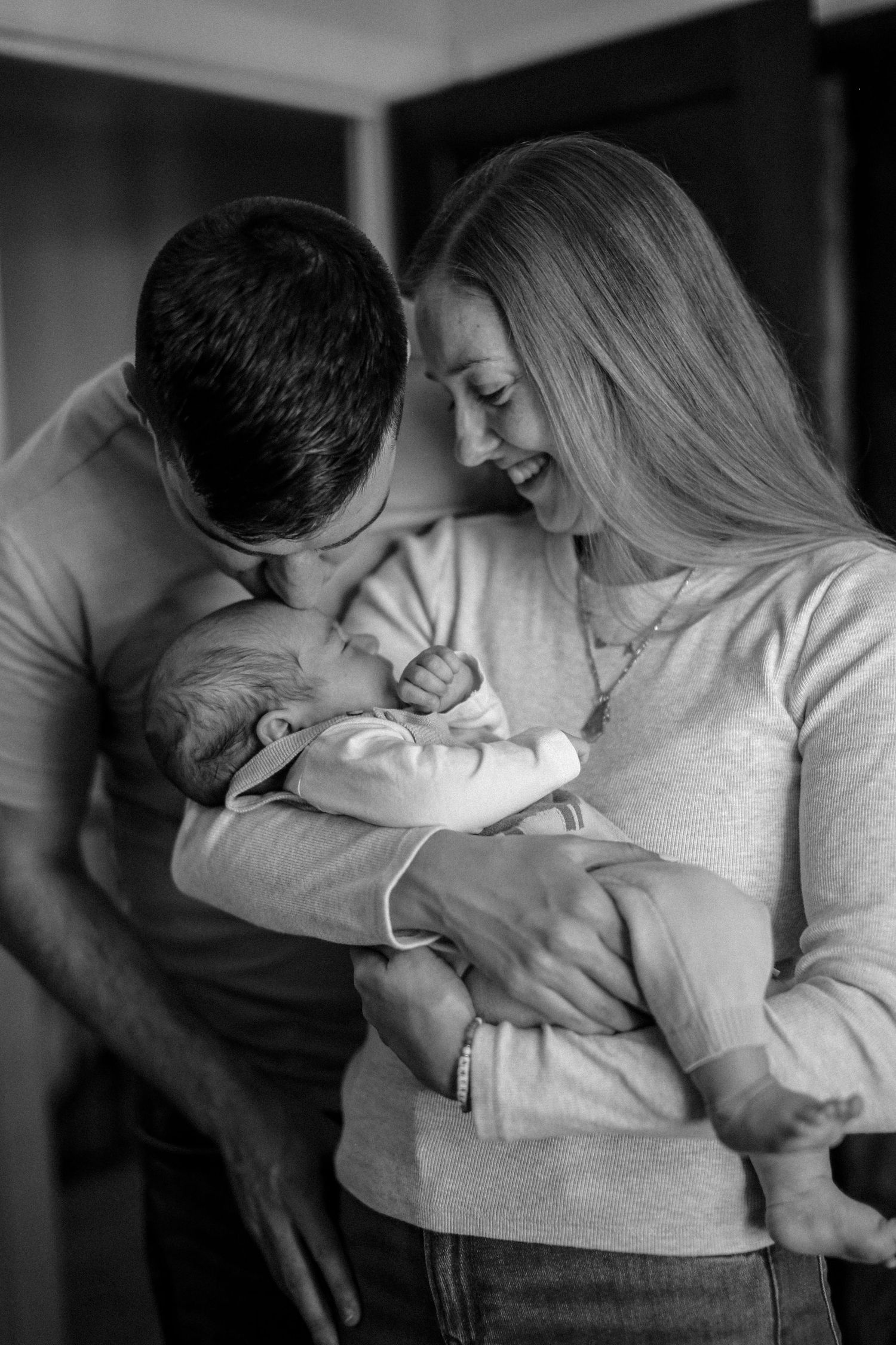 A series of intimate black and white photos showing tender moments between a couple embracing.