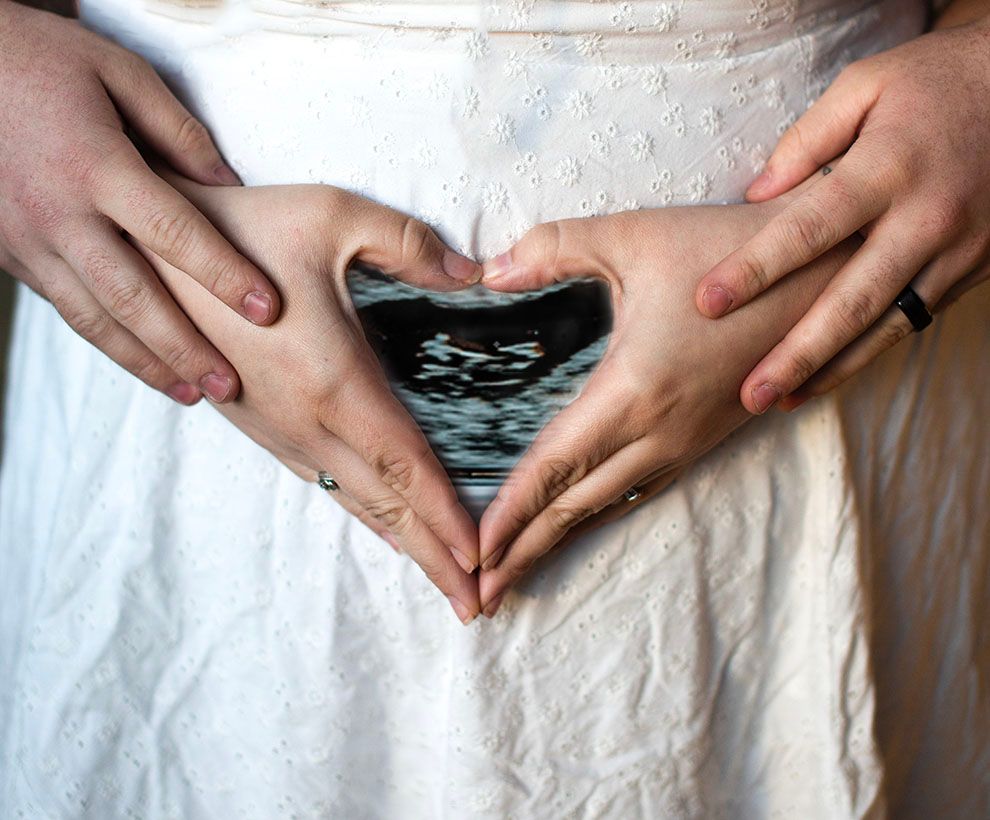 Close-up shots of hands gently resting on a pregnant belly in sequence.