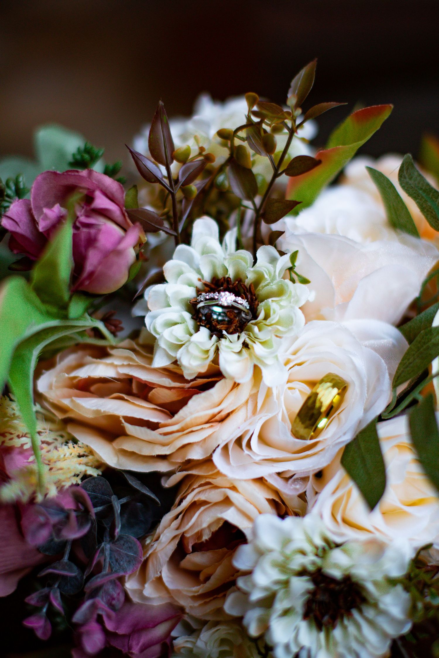 Close-up macro shots of peach roses and white flowers in a romantic wedding bouquet arrangement with dark background.