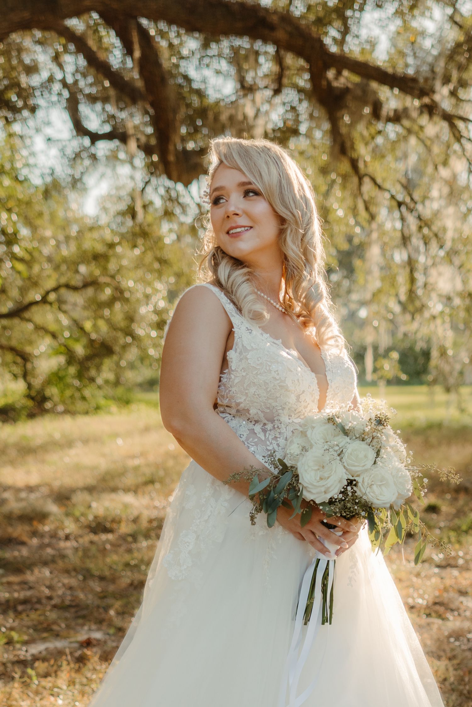 Woodberry Havana Weddings Tallahassee Wedding Photographer. Bride standing under mossy oak tree during golden hour