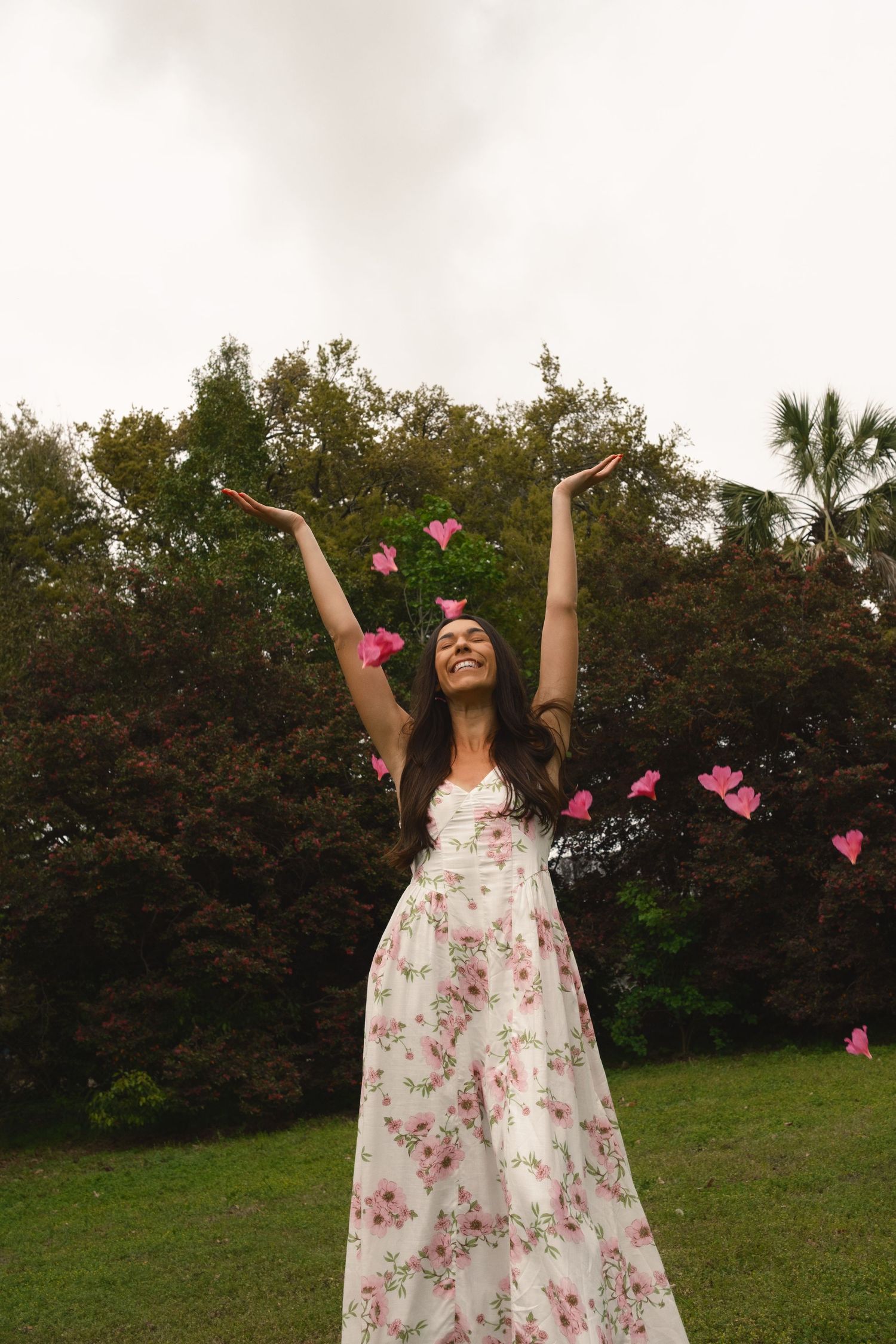 Charleston Spring Photoshoot a women throwing azaleas at Hampton Park