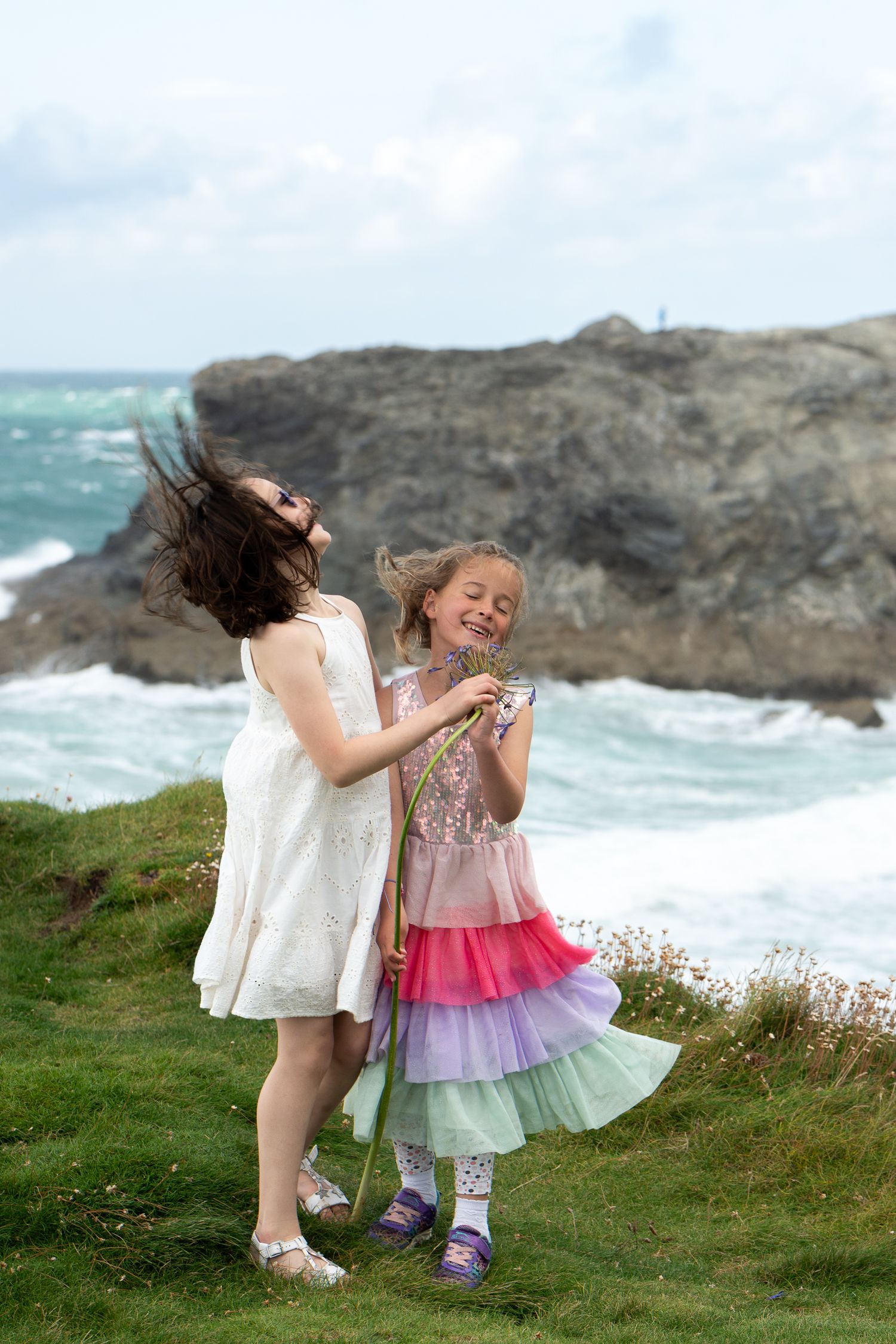 Portrait of children playing on a cliff in Cornwall, UK