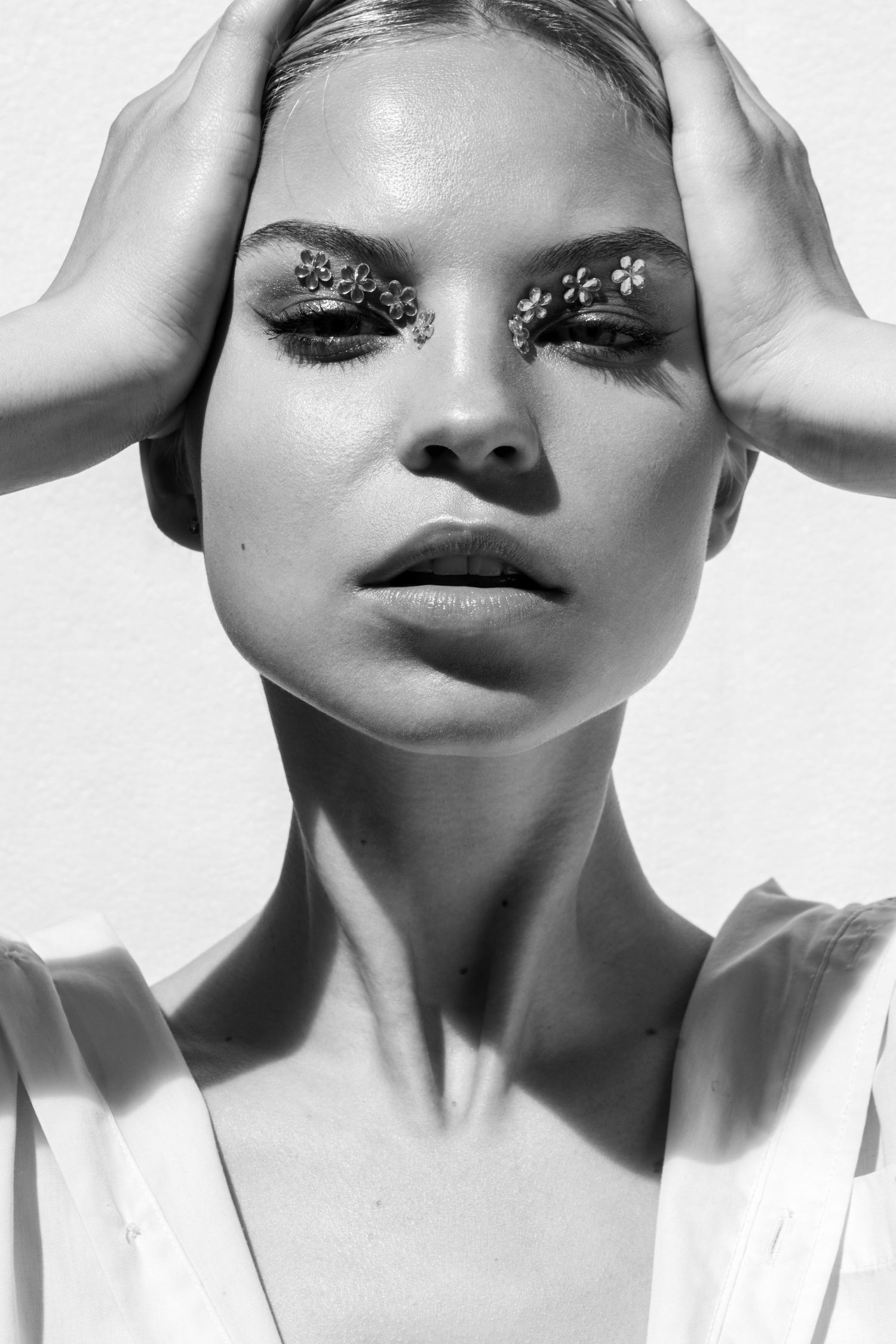 Black and white artistic portrait series showing dramatic lighting and shadows on a person's face with eyes closed.