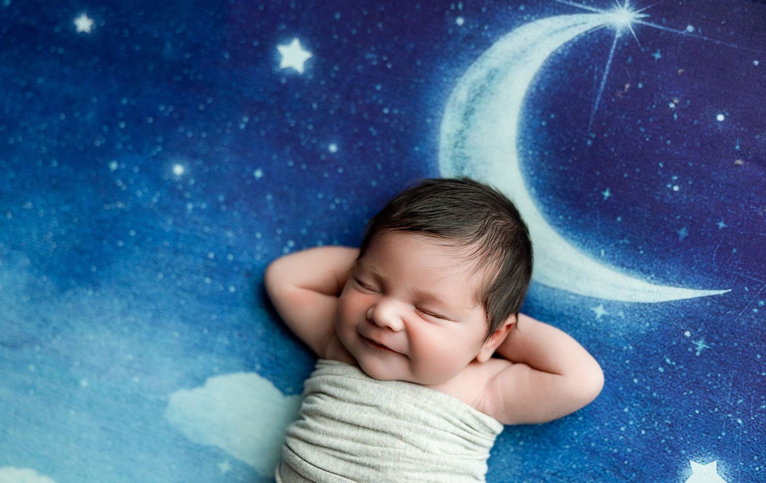 Collage of newborn baby photos with dreamy nighttime backgrounds featuring stars, moons, and blue celestial elements.