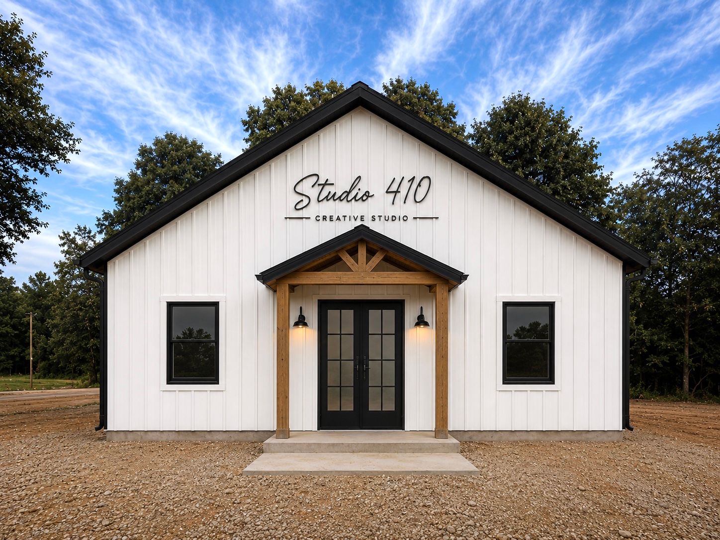 Studio 410 Creative Studio, a modern white farmhouse-style building with black trim and French doors.