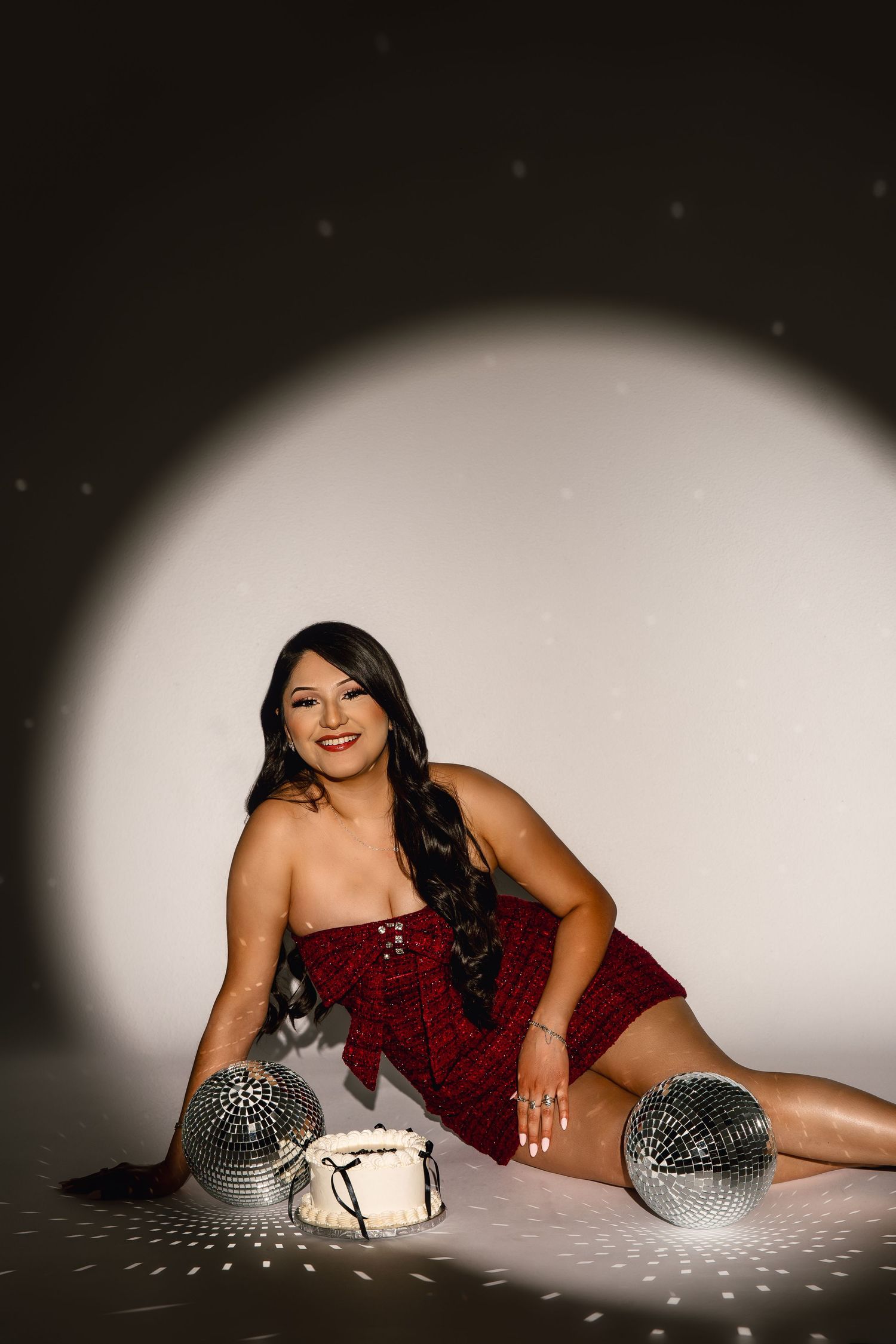 A festive holiday photo with disco balls and a spotlight effect creating sparkly reflections on a dark background.