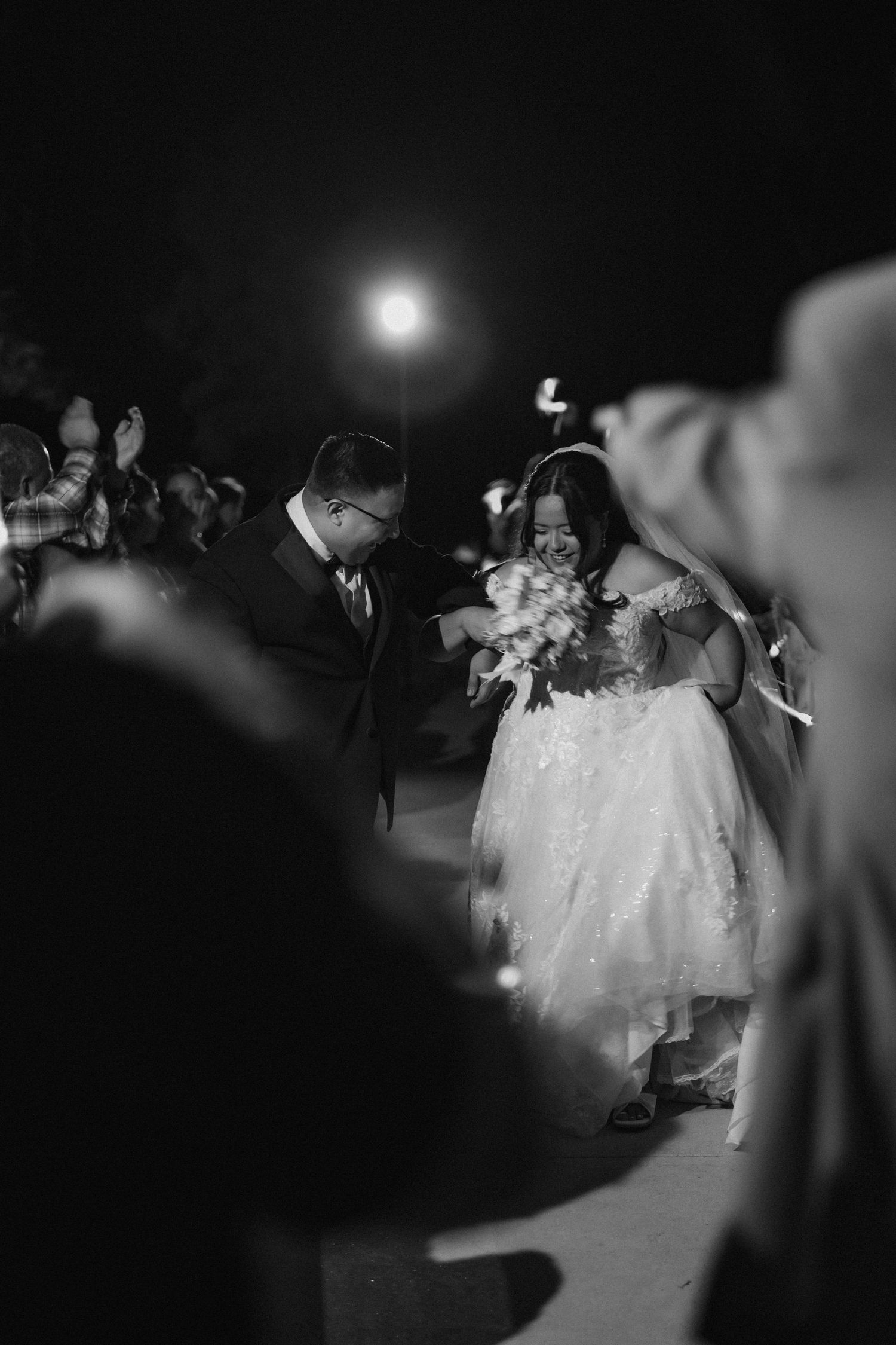 Black and white wedding send-off — groom and bride exiting through guests — KN KROMATIC Photography Houston wedding photographer.