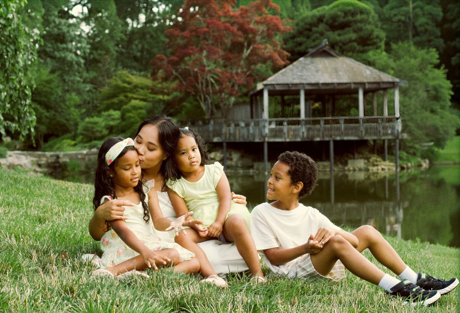 Washington DC, Maryland and Virginia candid family photographer capturing mother and children sitting together in a garden park