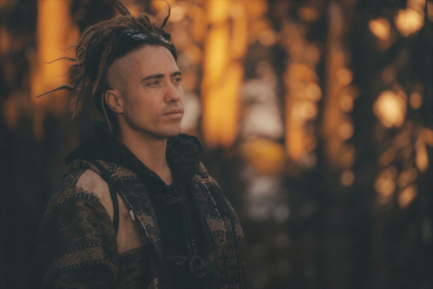 Man in profile against soft-focus boulders