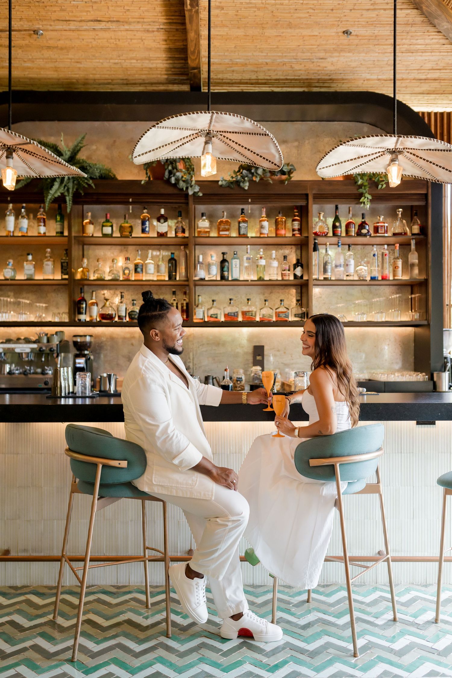 Couple enjoying a relaxed moment at the bar during a photography session at Andaz Peninsula Papagayo in Costa Rica.