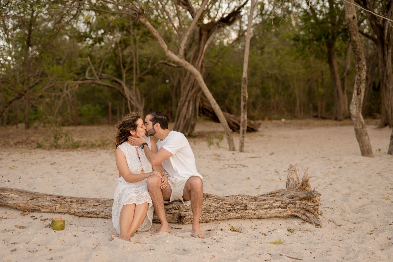 Family sitting together beneath the trees during a relaxed beach session near Reserva Conchal, Costa Rica