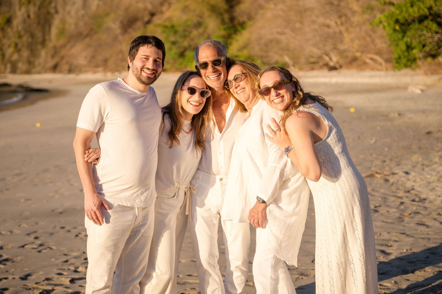 Family smiling together during a golden hour beach photography session at Four Seasons Costa Rica at Peninsula Papagayo.
