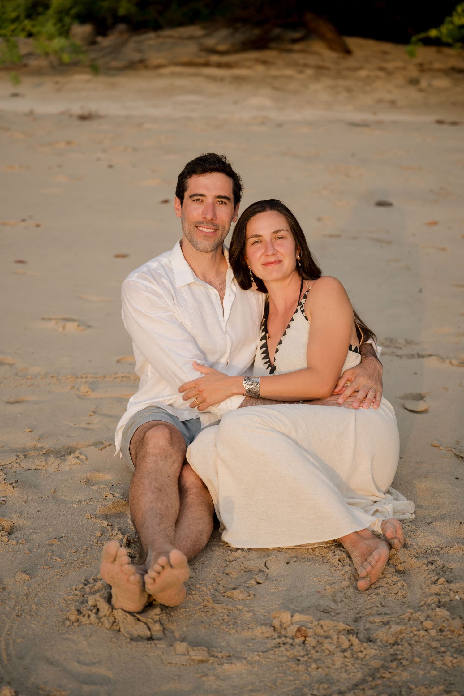Couple sitting together on the beach during a family vacation photography session at Four Seasons Peninsula Papagayo, Costa Rica.