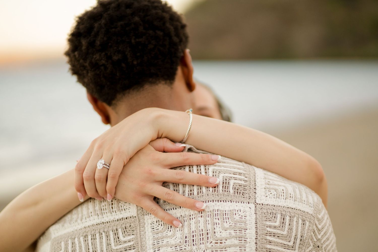 Newly engaged couple embracing with her engagement ring visible during their Andaz Costa Rica photography session.