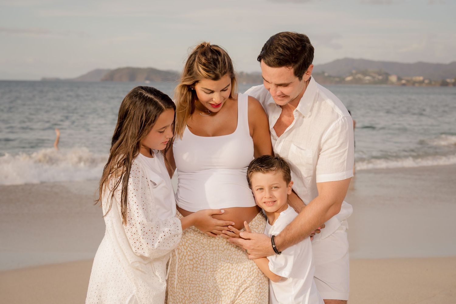 Parents with their young children during a family and maternity photo session at Playa Conchal, Costa Rica.