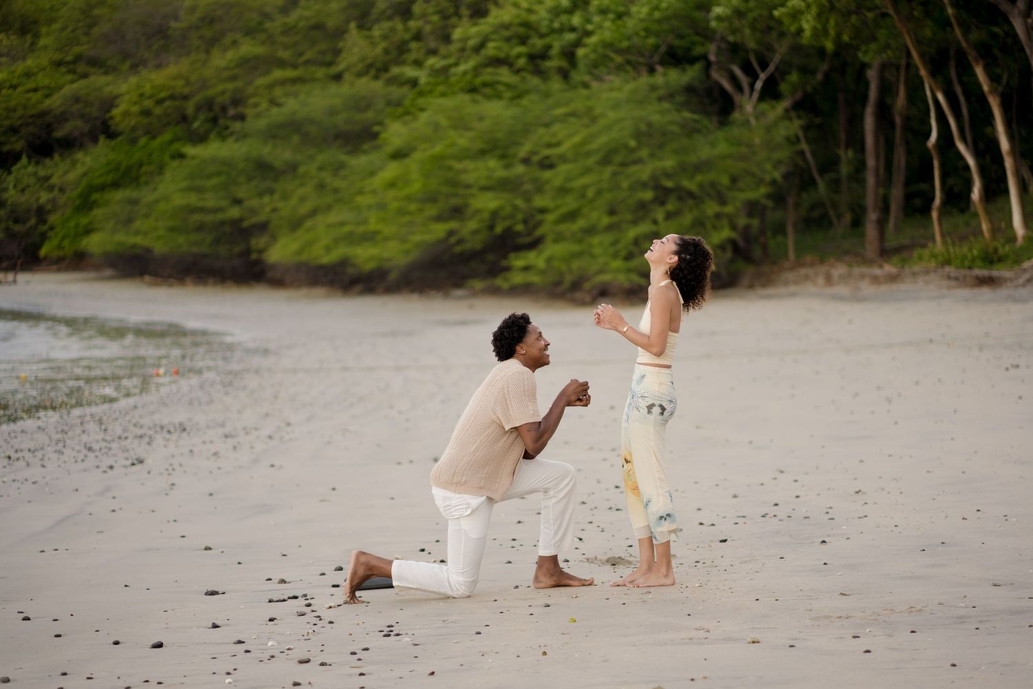 Surprise beach proposal during a romantic couple photography session at Four Seasons Resort Peninsula Papagayo, Costa Rica.