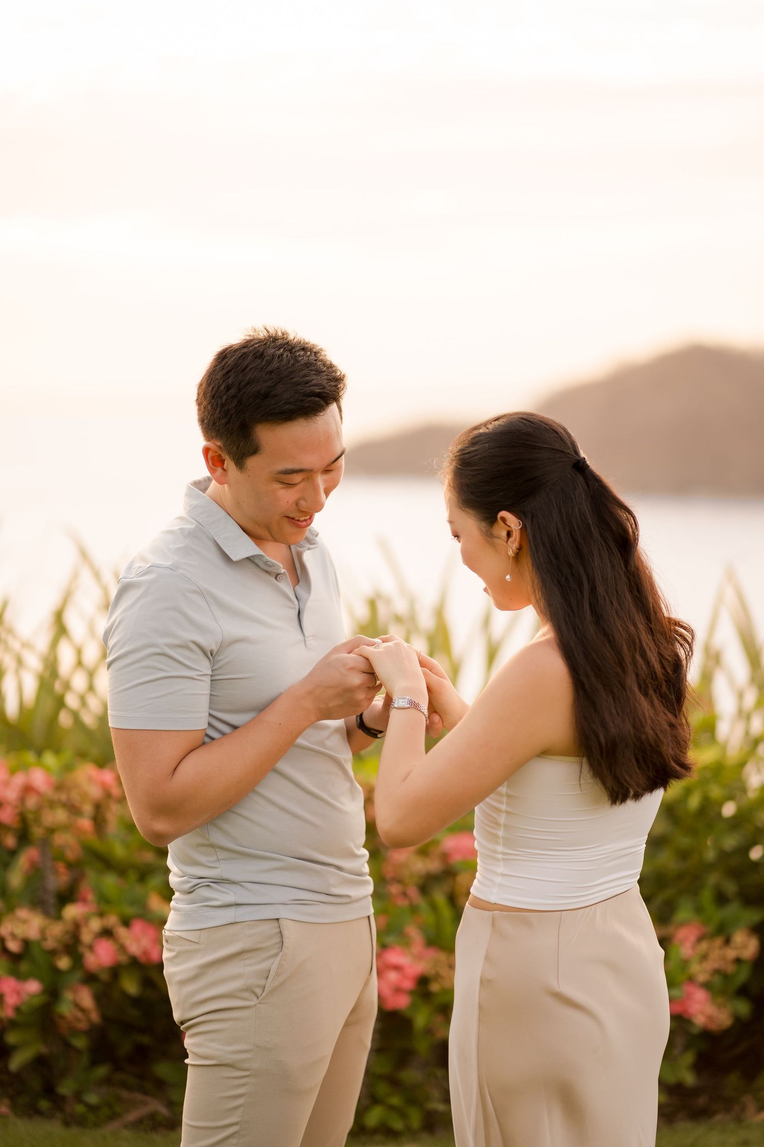 Engaged couple looking at the ring during a romantic sunset photography session in Costa Rica.