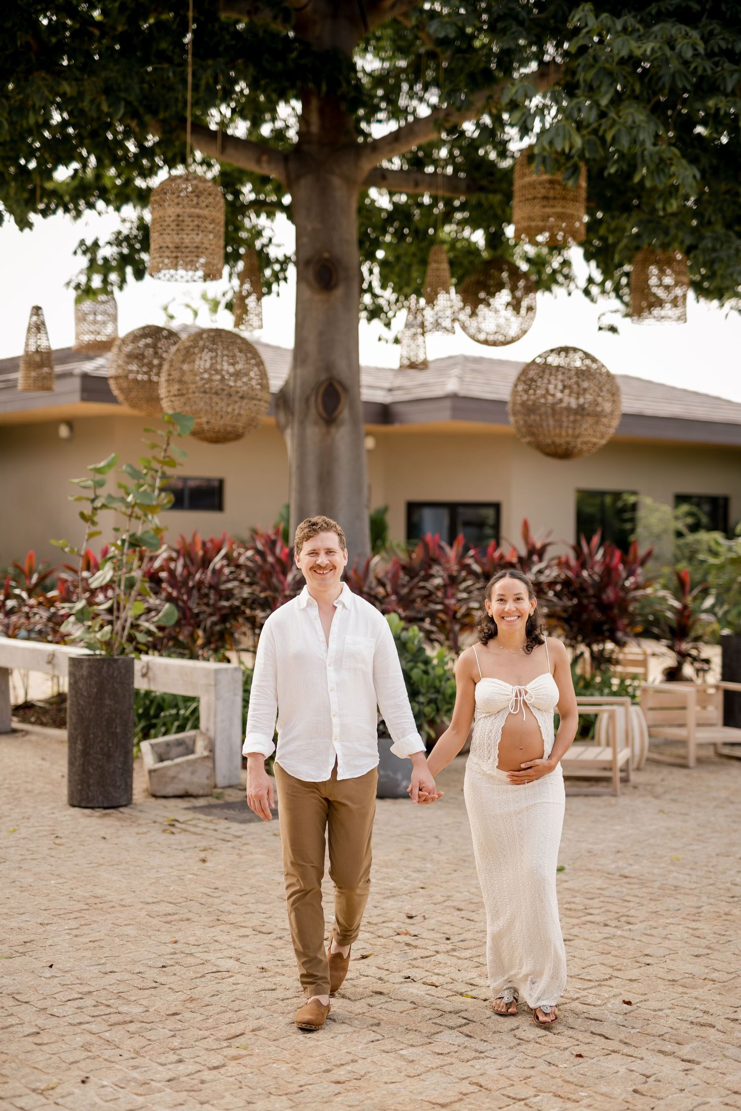 Expecting couple walking together during a luxury babymoon photography session at Nekajui, a Ritz-Carlton Reserve in Costa Rica.