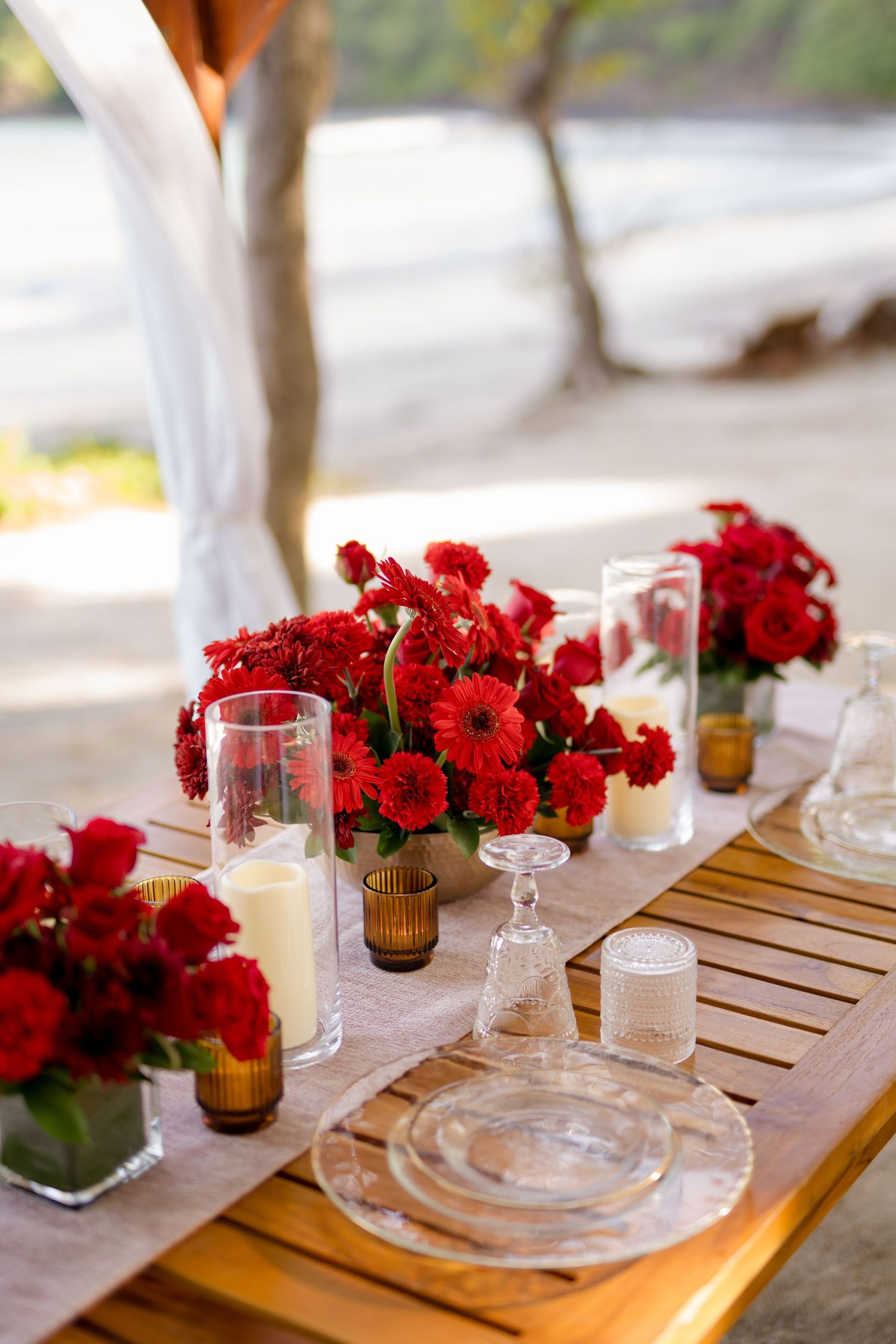 Romantic engagement dinner decor with red roses and candles at Andaz Peninsula Papagayo in Costa Rica.