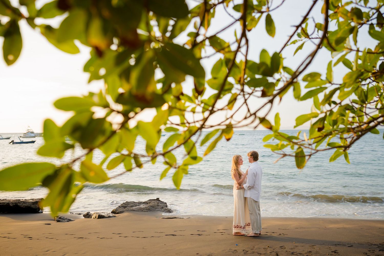 Engaged couple sharing a romantic moment on the beach at Four Seasons Costa Rica at Peninsula Papagayo.