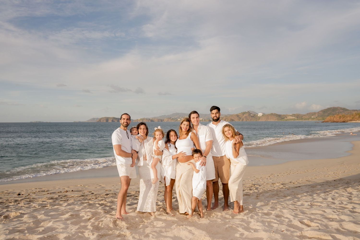 Multi-generational family gathered on the beach during a family photography session at Playa Conchal, Costa Rica.
