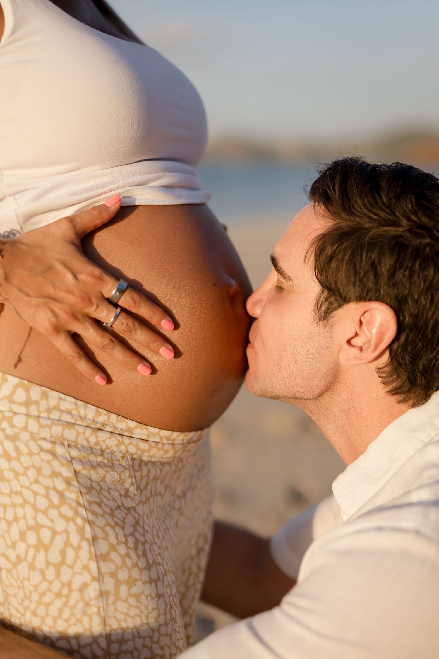 Close-up maternity portrait of an expecting couple during their beach session in Playa Conchal, Costa Rica.
