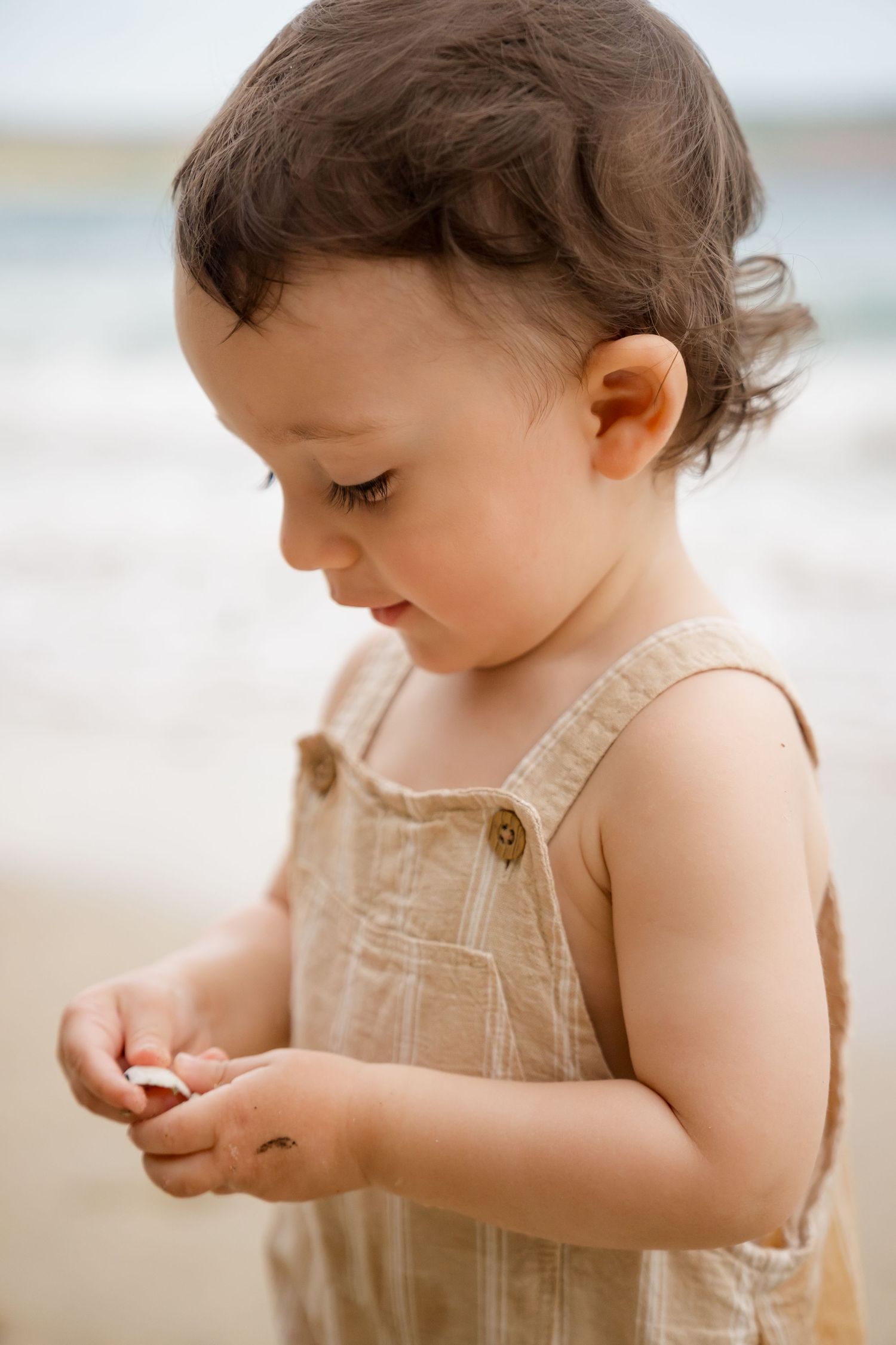 Young child playing on the beach during a family photography session at Andaz Peninsula Papagayo, Costa Rica.