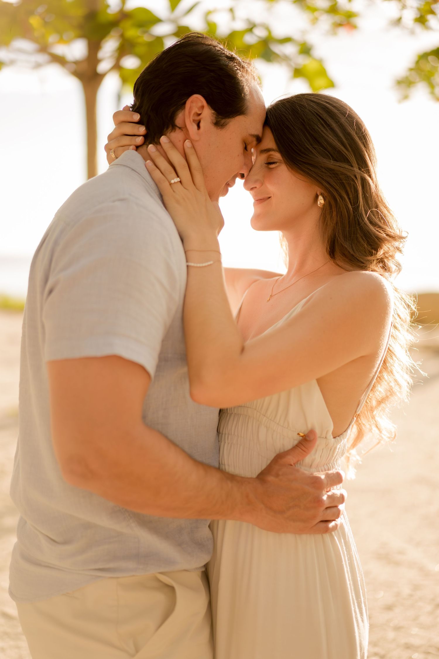 Couple embracing in warm golden light during a sunset photography session at Hacienda Pinilla in Guanacaste, Costa Rica.