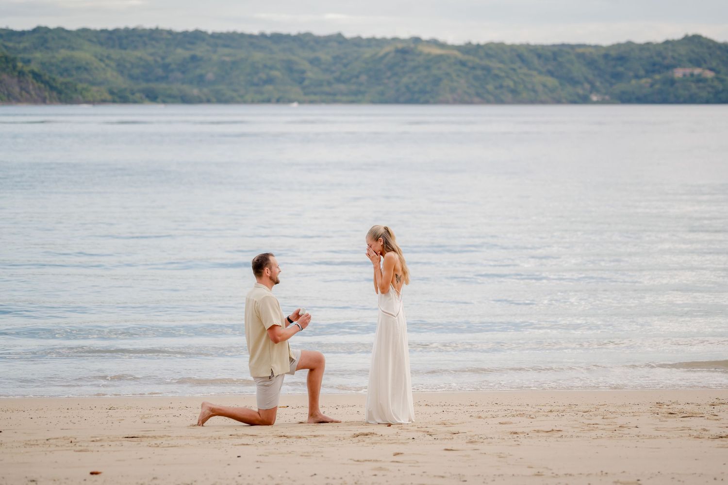Surprise beach proposal during a romantic couple photography session at Andaz Peninsula Papagayo in Costa Rica.