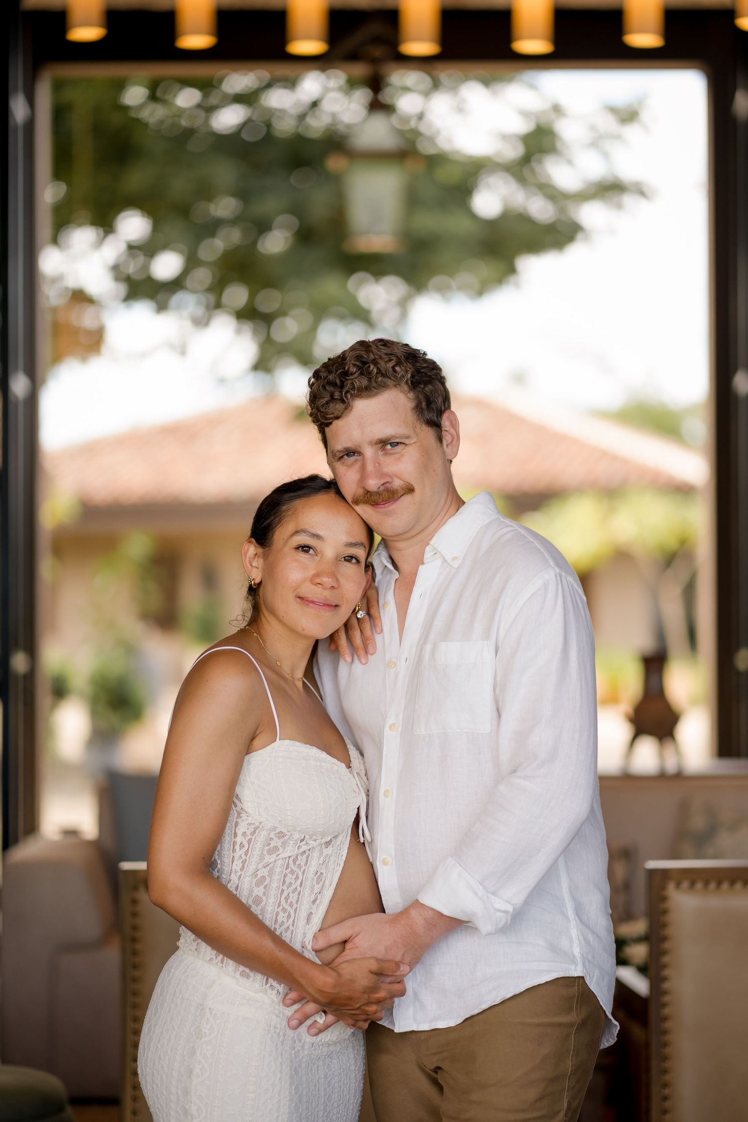 Expecting couple posing together during a babymoon photography session at Nekajui, a Ritz-Carlton Reserve in Costa Rica.