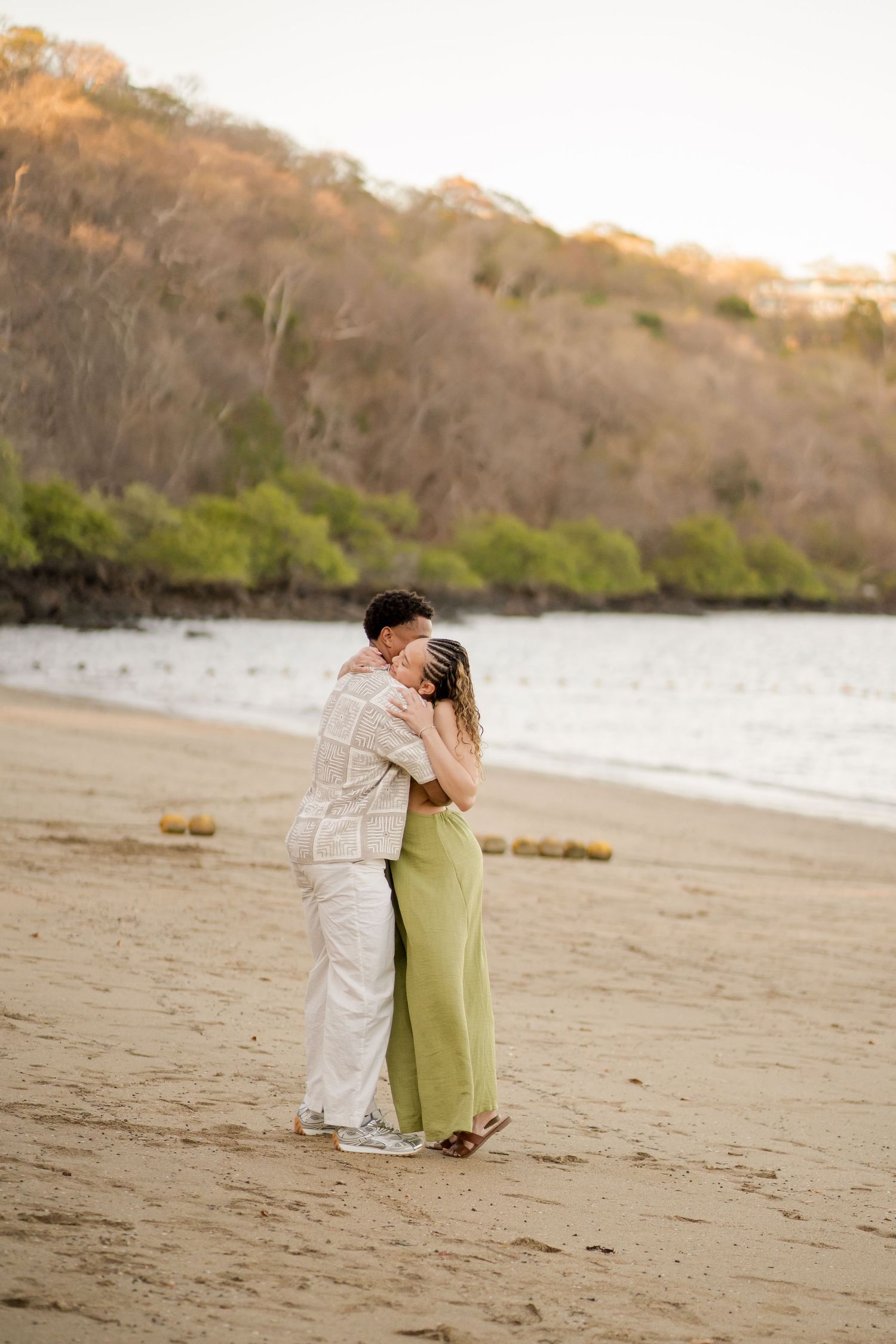Newly engaged couple embracing on the beach at Andaz Costa Rica in Peninsula Papagayo.