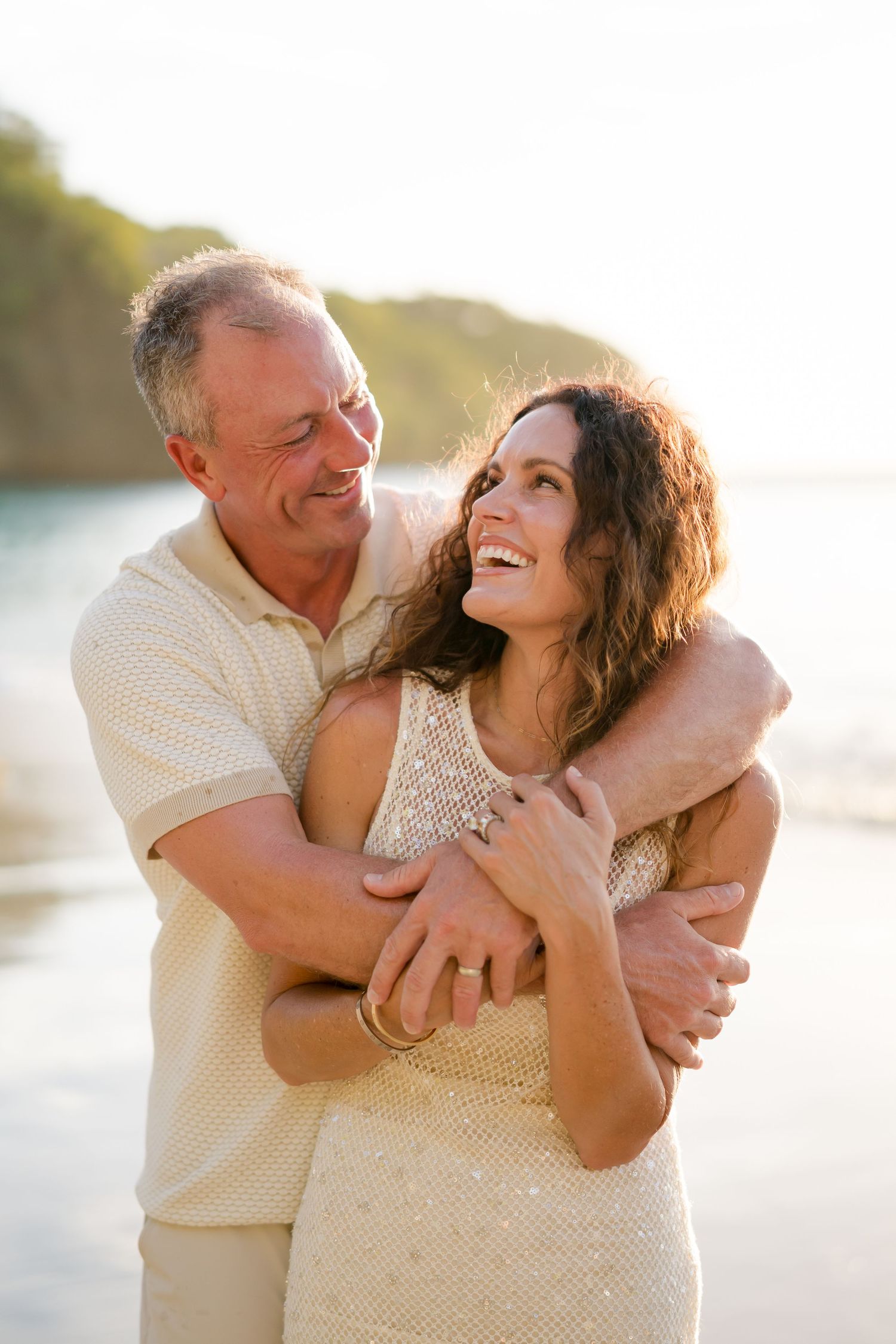 Couple laughing together on the beach during a relaxed family photography session at Four Seasons Costa Rica in Peninsula Papagayo.