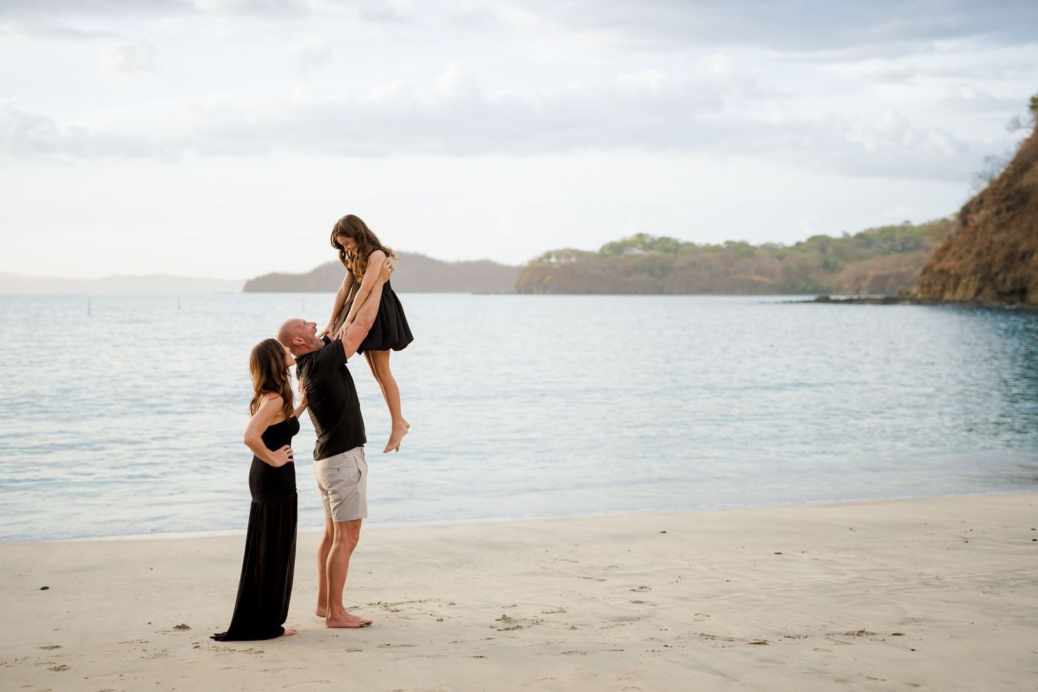 Parents with their daughter during a beach family photography session at Four Seasons Costa Rica at Peninsula Papagayo.