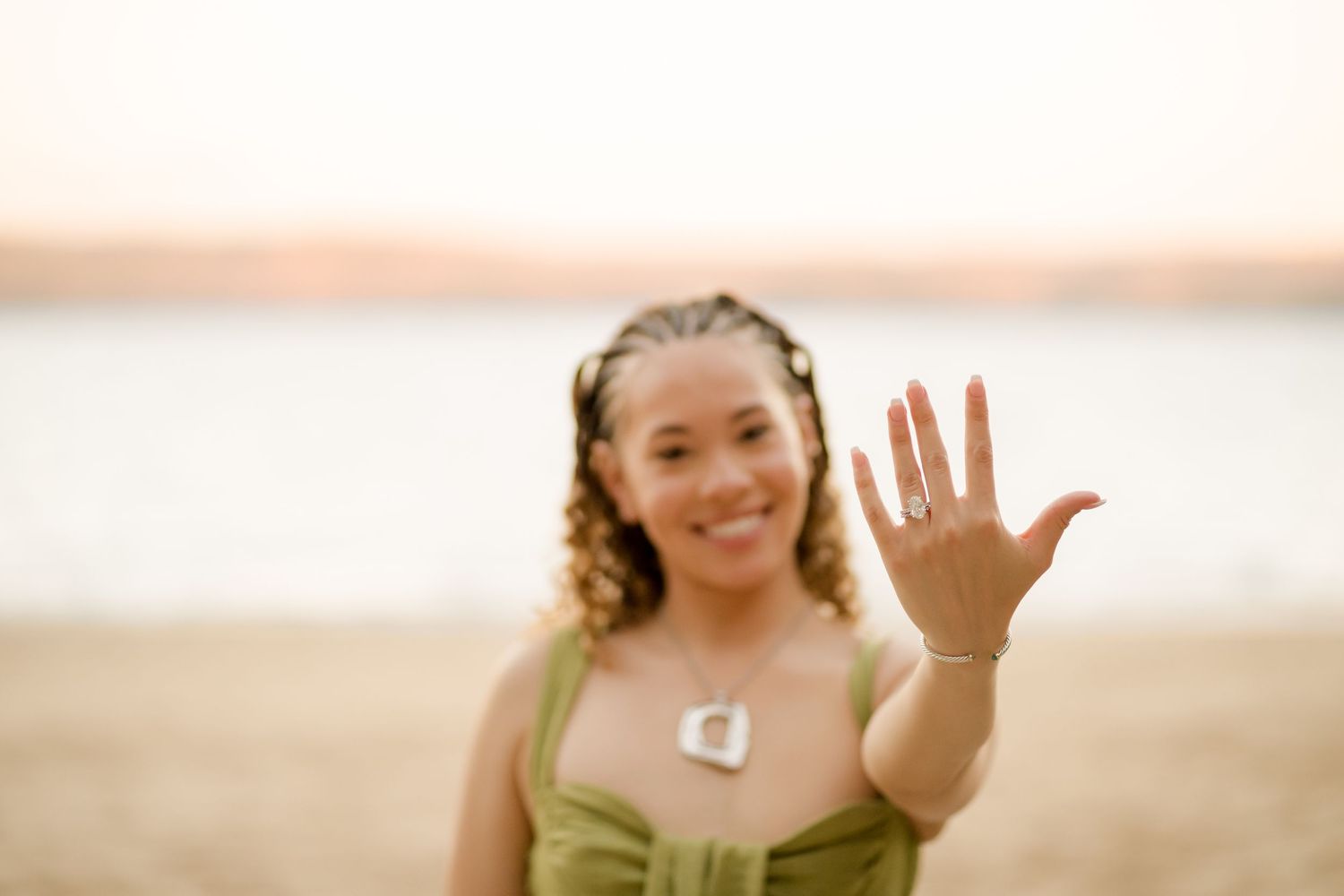 Newly engaged woman showing her engagement ring during a beach photography session at Andaz Costa Rica.