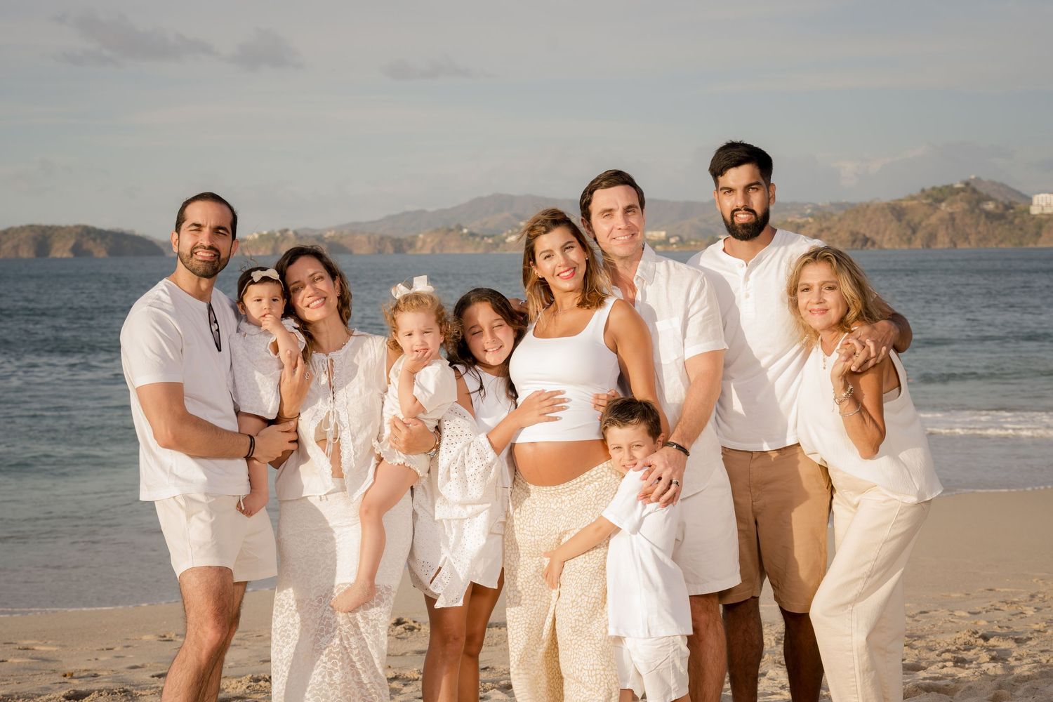 Family portrait with parents and children on the beach near Reserva Conchal in Guanacaste, Costa Rica.