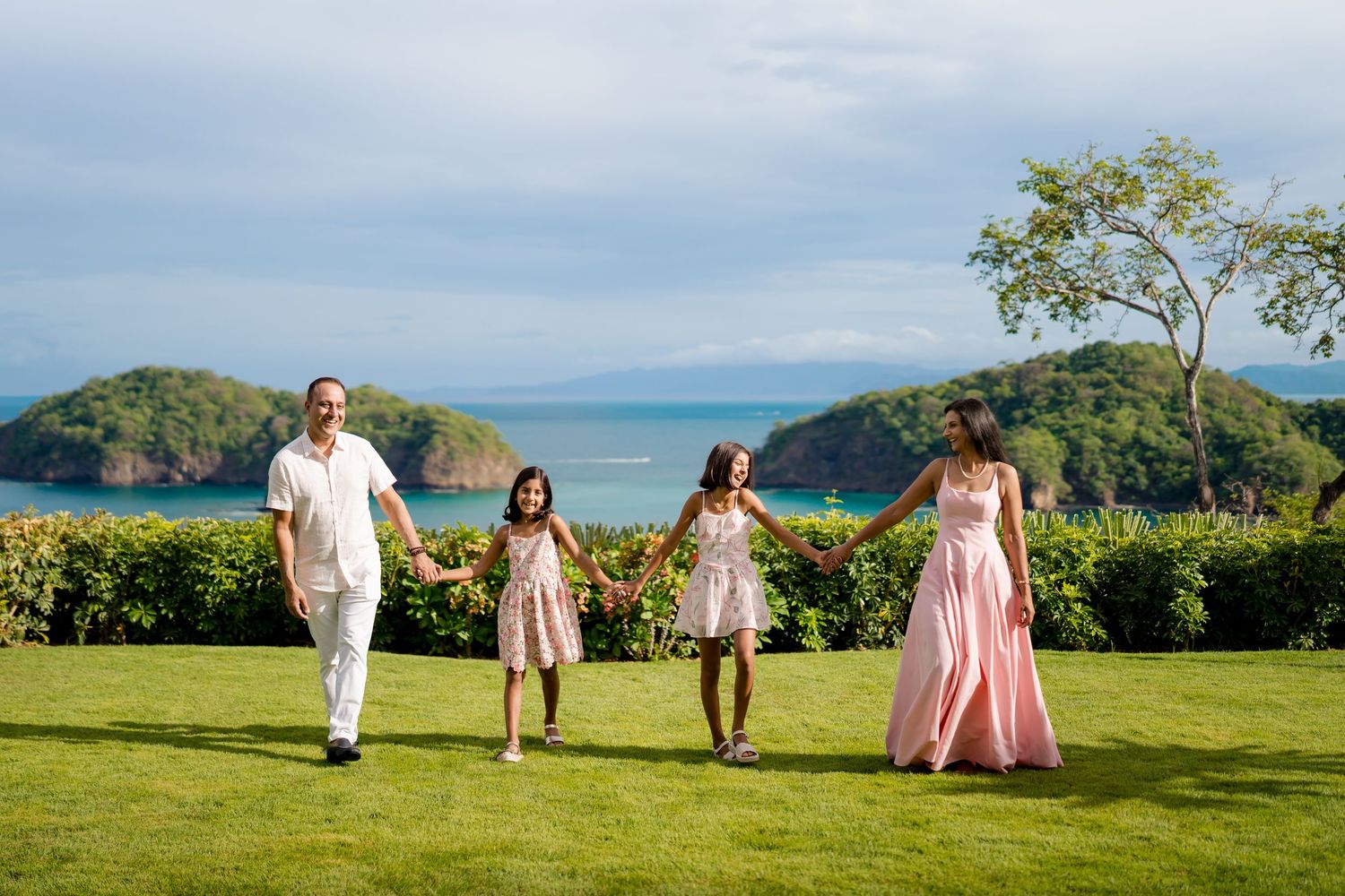 Family walking together through the gardens at Nekajui, a Ritz-Carlton Reserve in Peninsula Papagayo, Costa Rica.