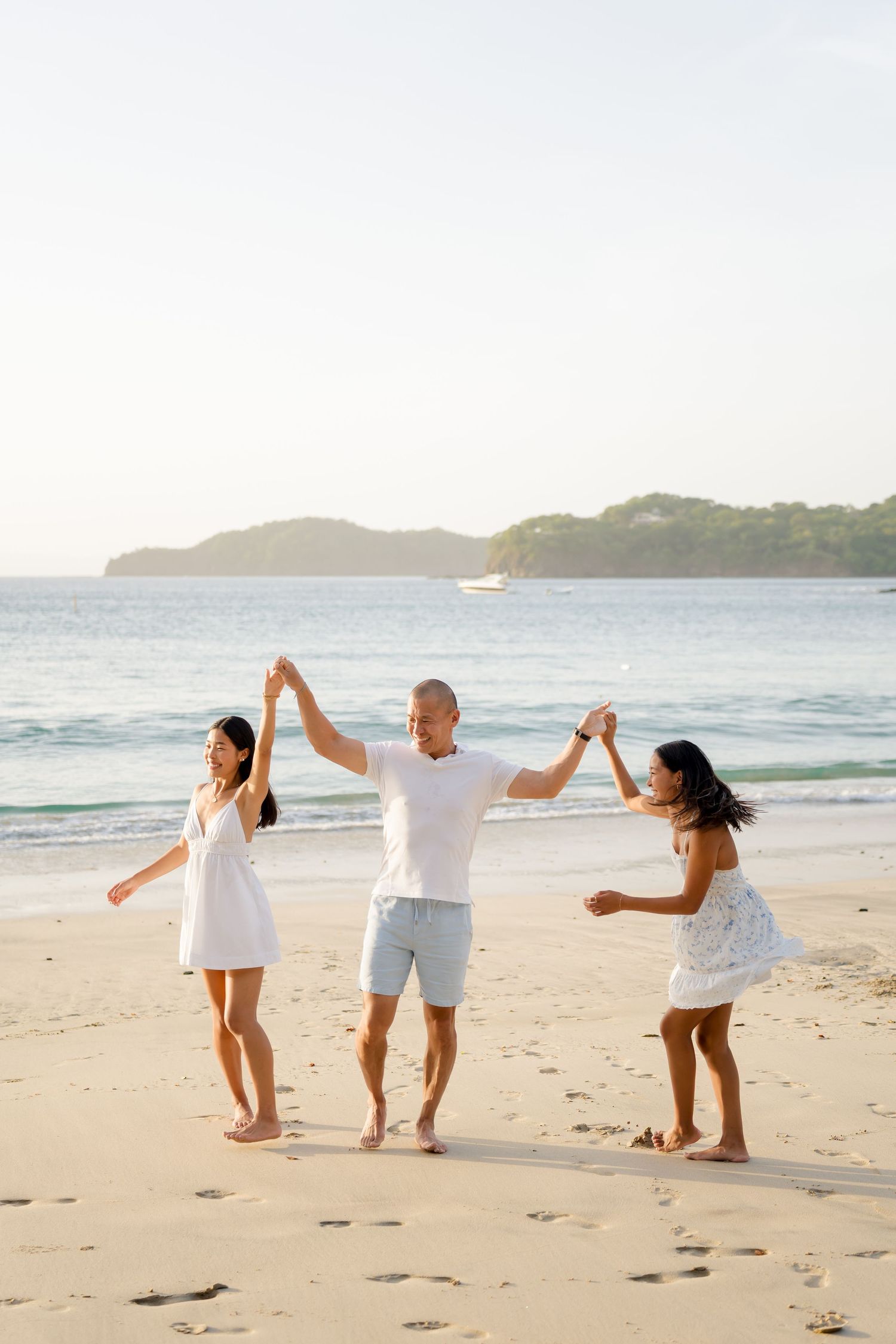 Family playing together on the beach during a vacation photography session at Four Seasons Peninsula Papagayo, Costa Rica.