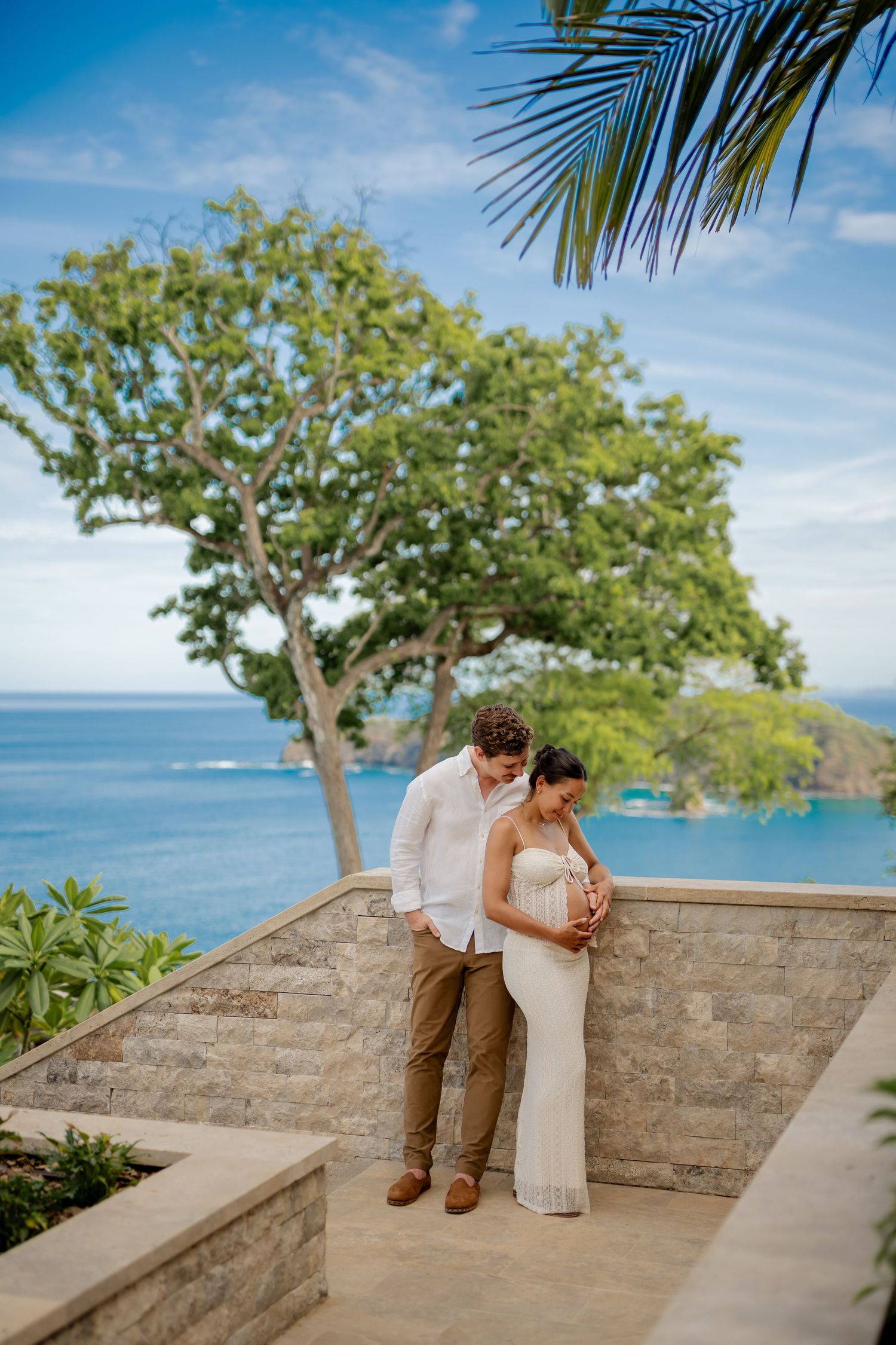 Expecting couple embracing during a babymoon photography session at Nekajui, a Ritz-Carlton Reserve in Peninsula Papagayo.