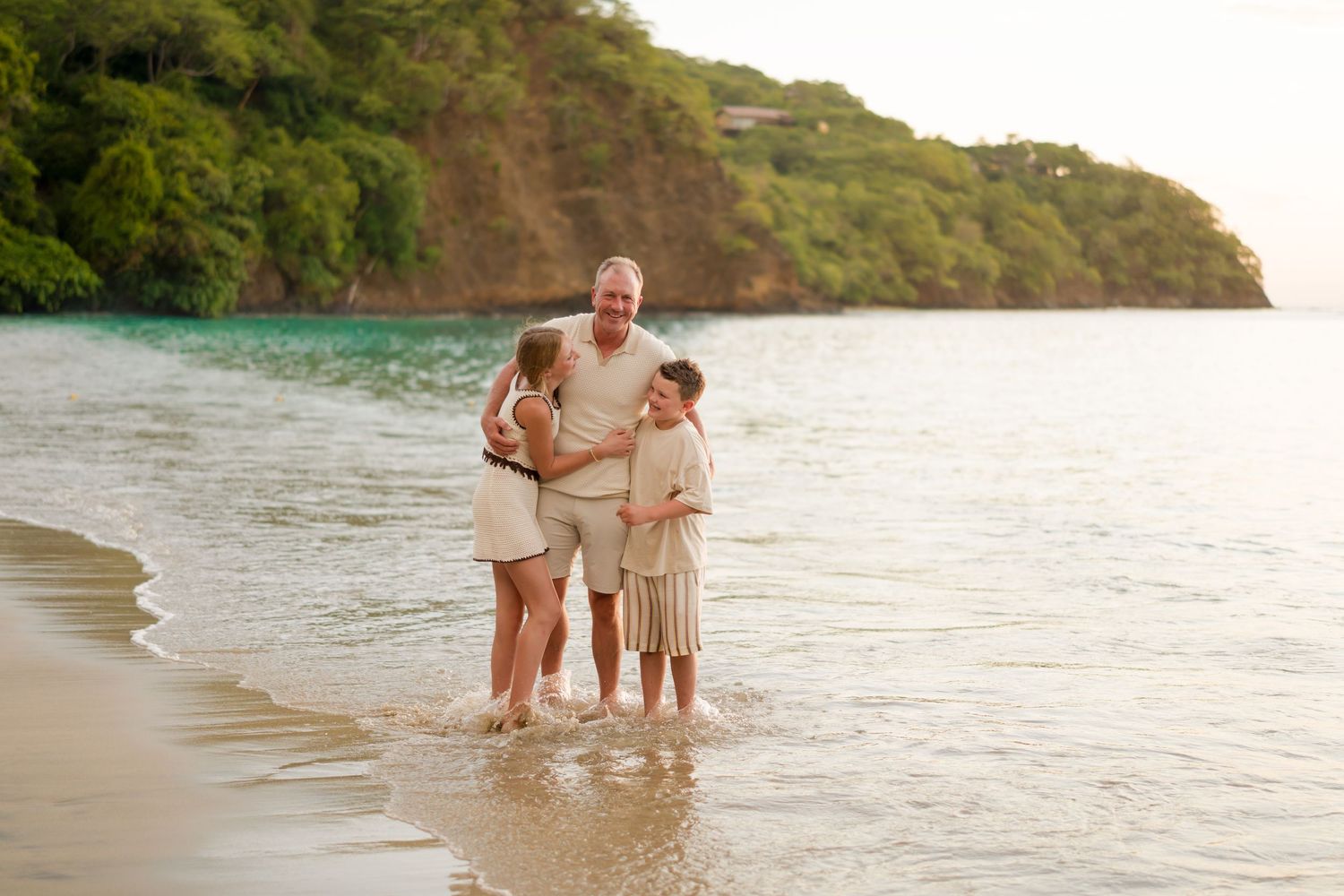 Father with his son and daughter by the ocean during a family photography session at Four Seasons Costa Rica in Peninsula Papagayo.