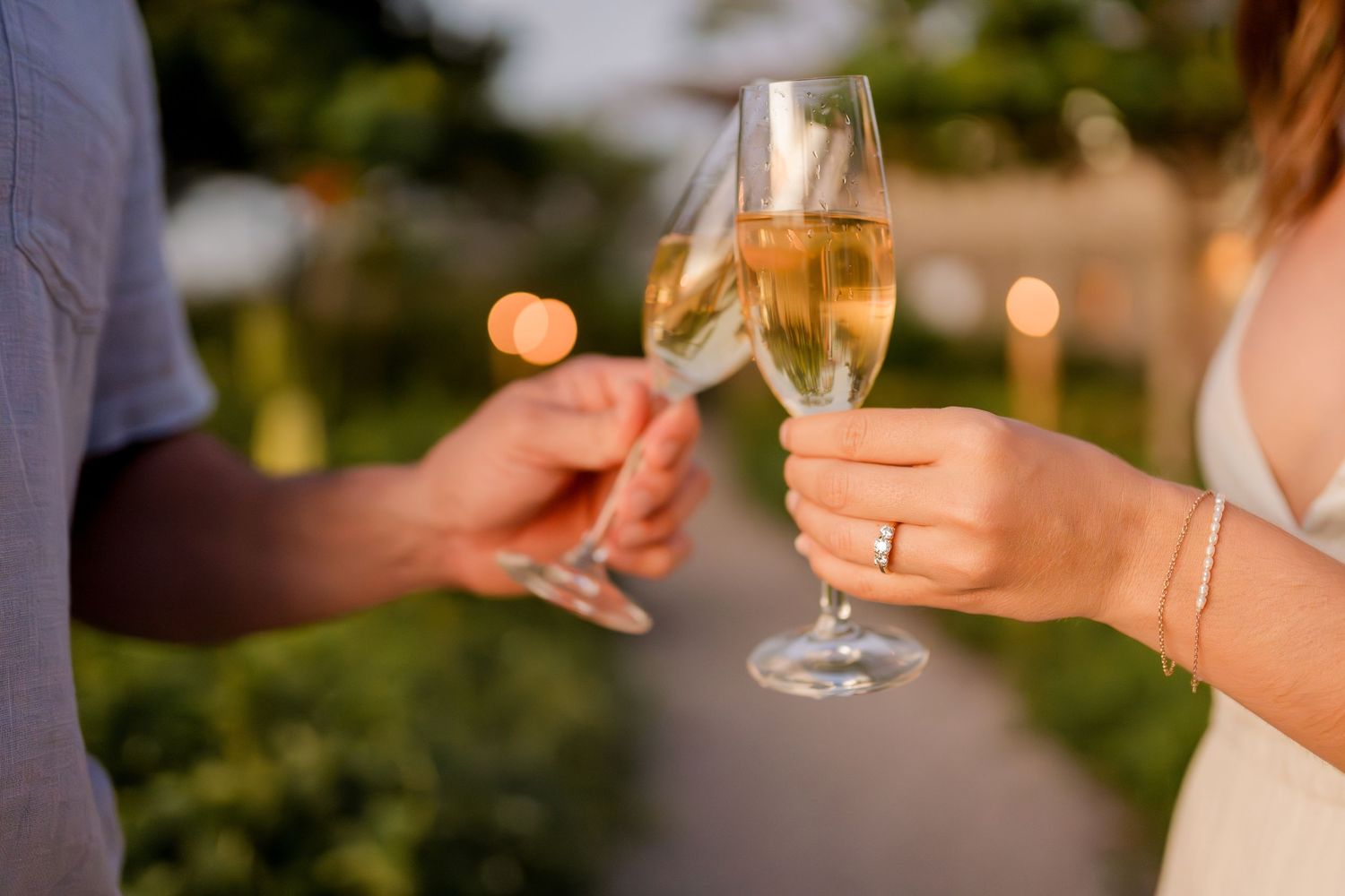 Engaged couple toasting with champagne and showing the engagement ring during a romantic Costa Rica photography session.