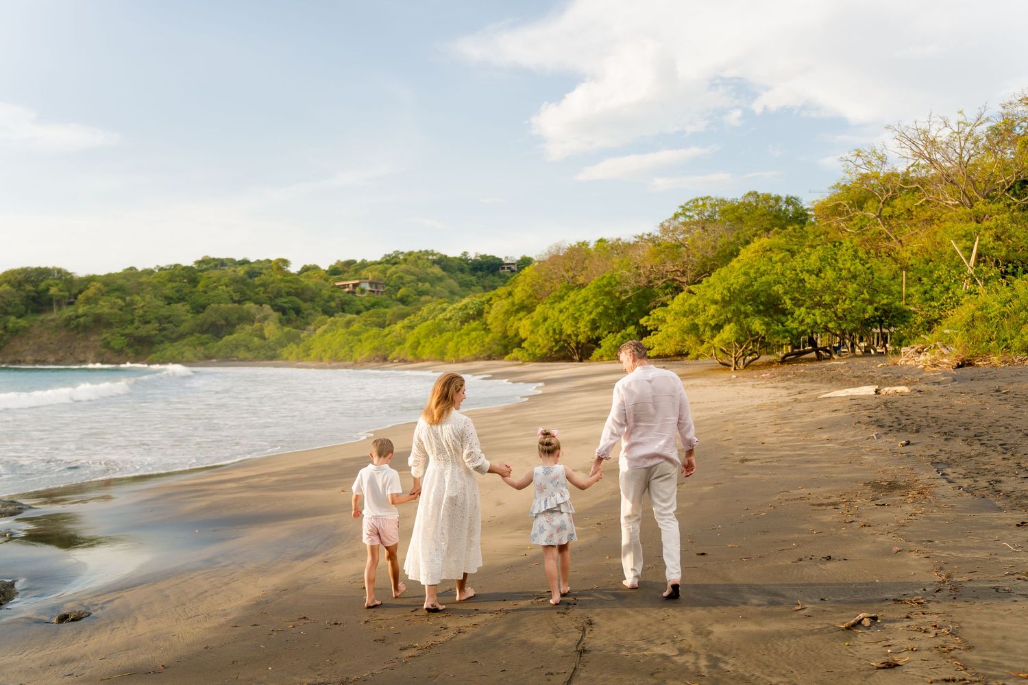 Family walking together along the beach during a family photography session in Peninsula Papagayo, Costa Rica.