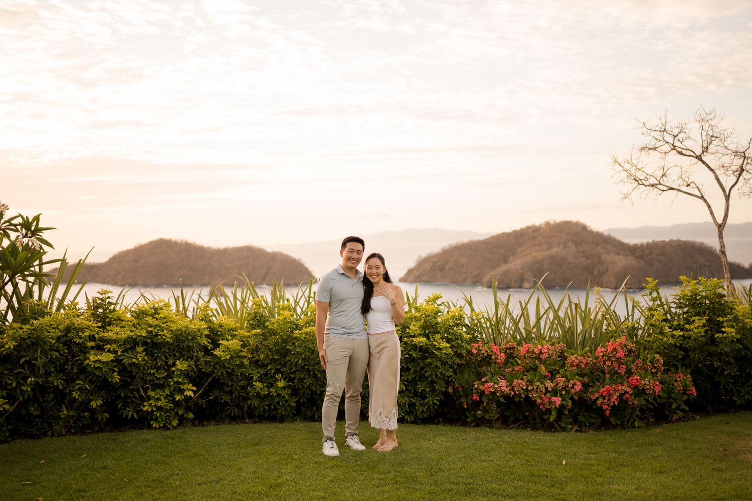 Couple embracing during a sunset photography session overlooking the coast in Costa Rica.