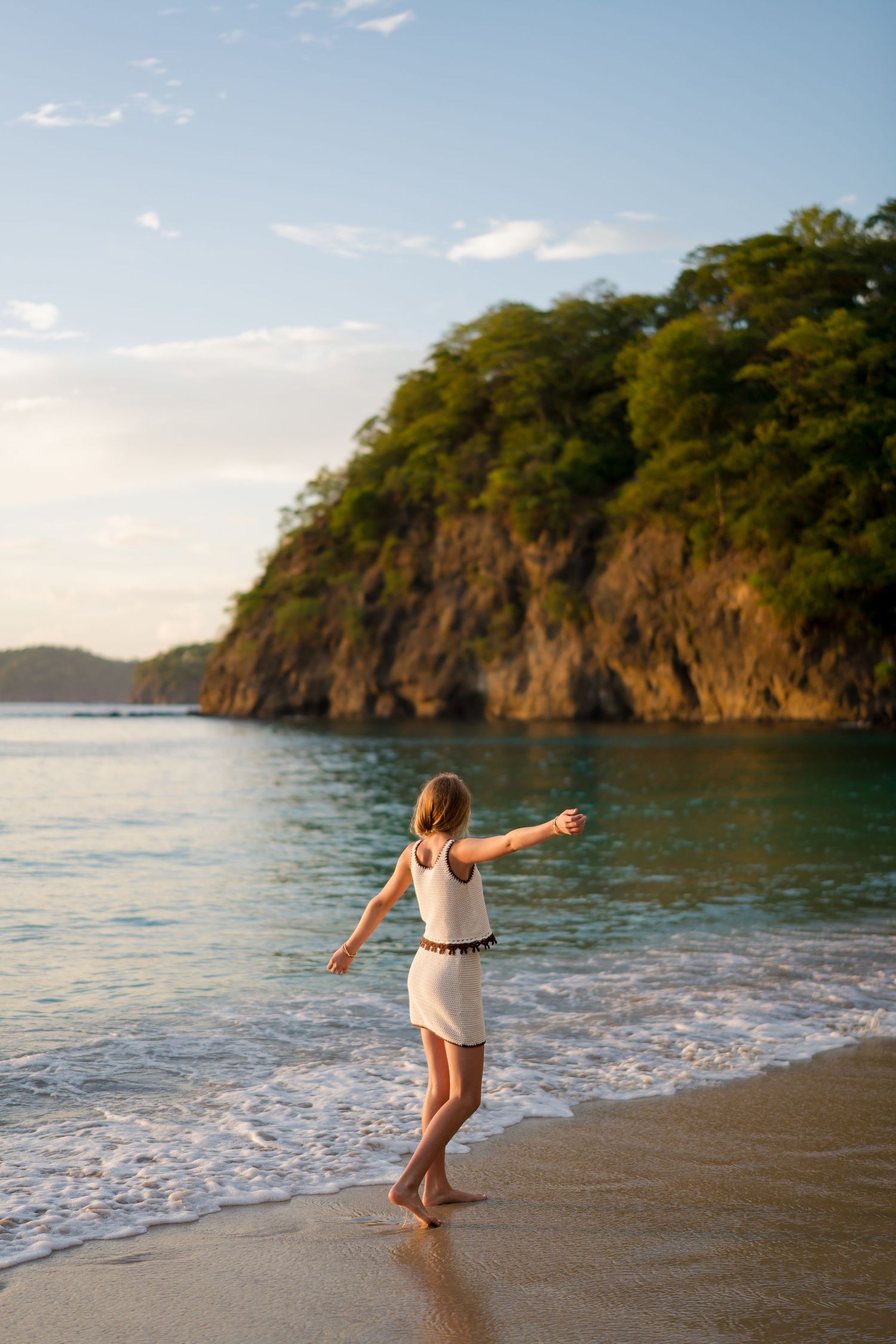 Child playing by the ocean during a family photography session in Peninsula Papagayo, Costa Rica.