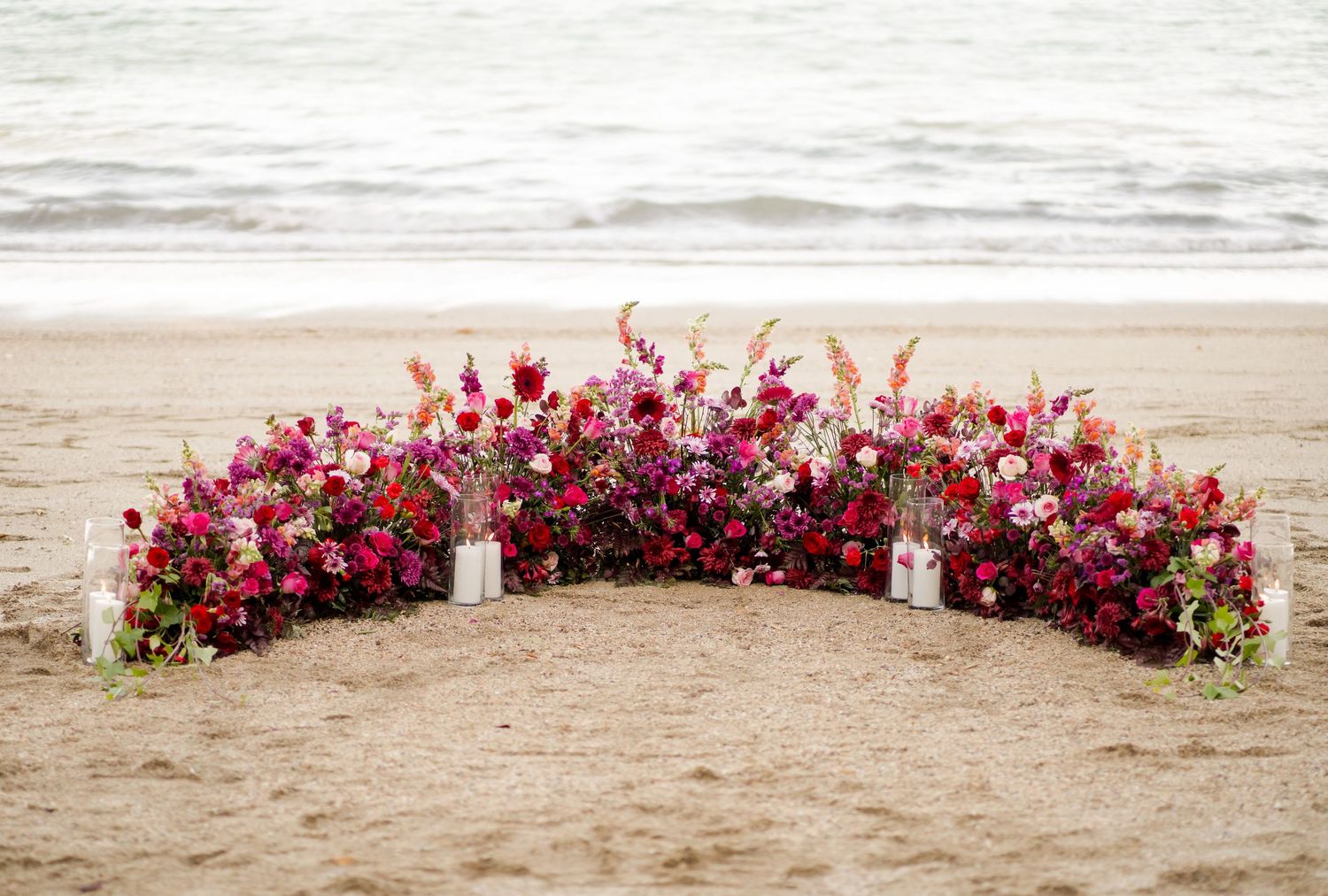 Colorful floral beach proposal setup overlooking the ocean at Andaz Costa Rica in Peninsula Papagayo.